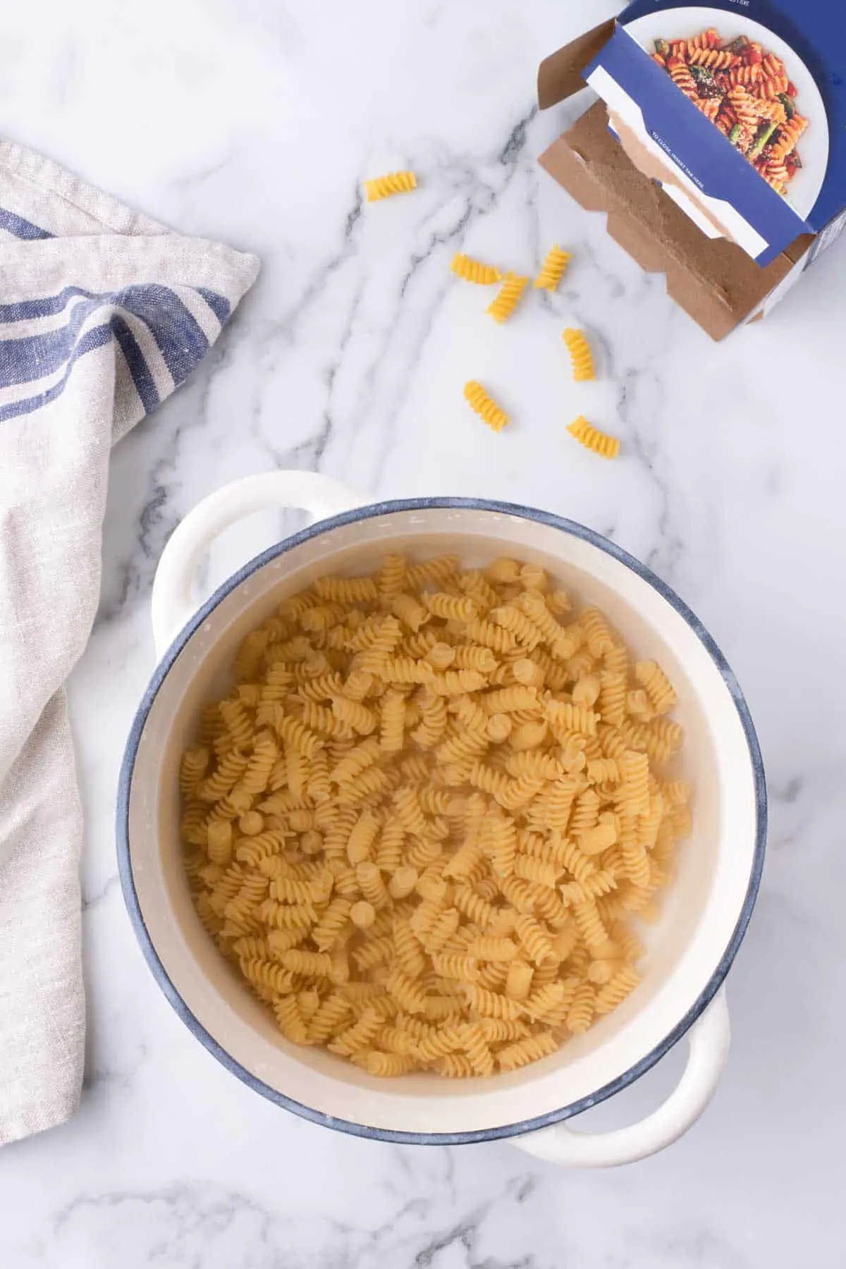 rotini noodles cooking in a pot of boiling water