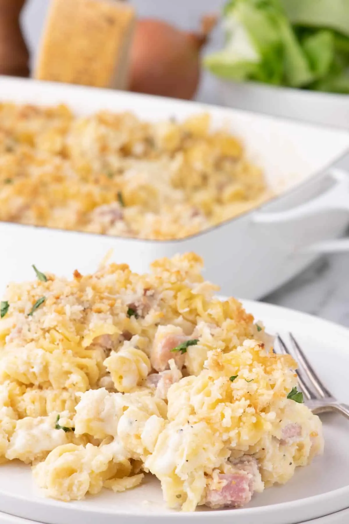 Ham and Noodle Casserole is a hearty casserole loaded with rotini pasta and diced ham all coated in a cheesy bubbling sauce under a parmesan coated panko crust.