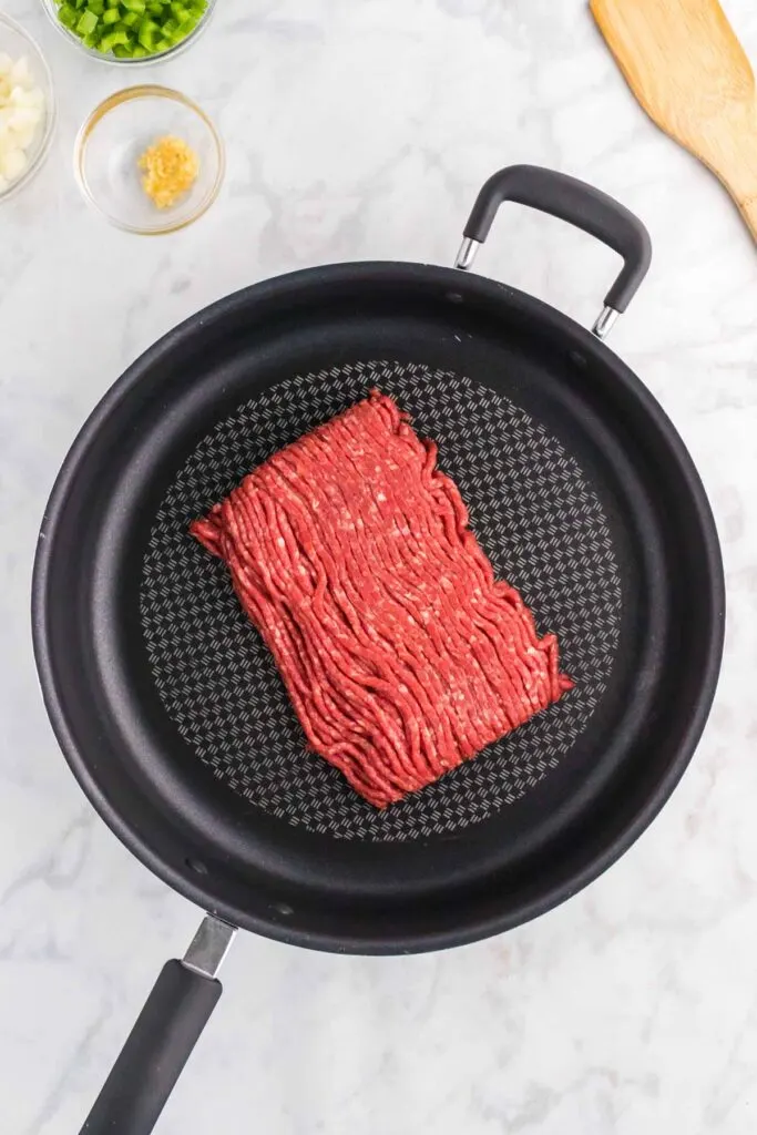 raw ground beef in a skillet