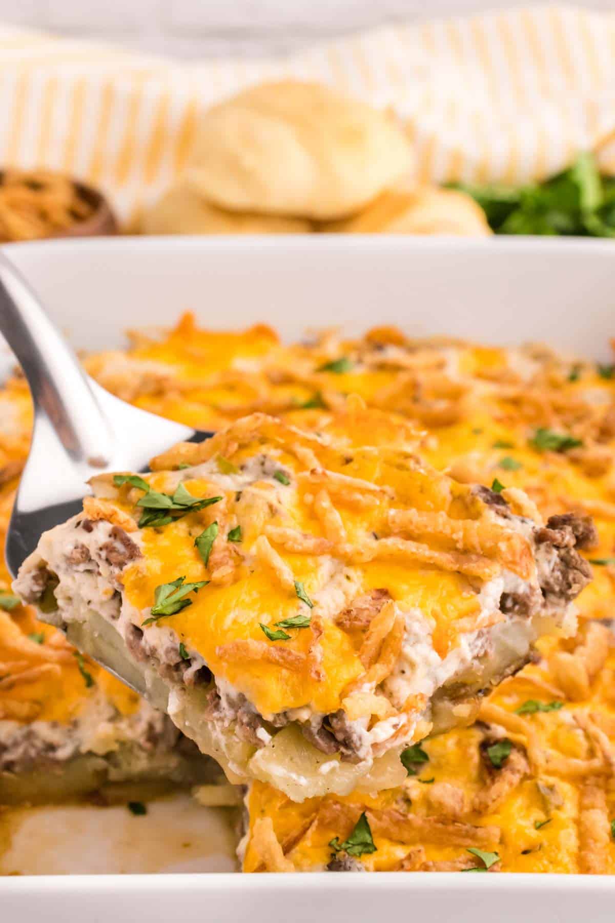 Hobo Casserole is a layered ground beef and sliced potato casserole loaded with diced bell peppers, onions, sour cream, cream of mushroom soup, cheddar cheese and French's crispy fried onions.