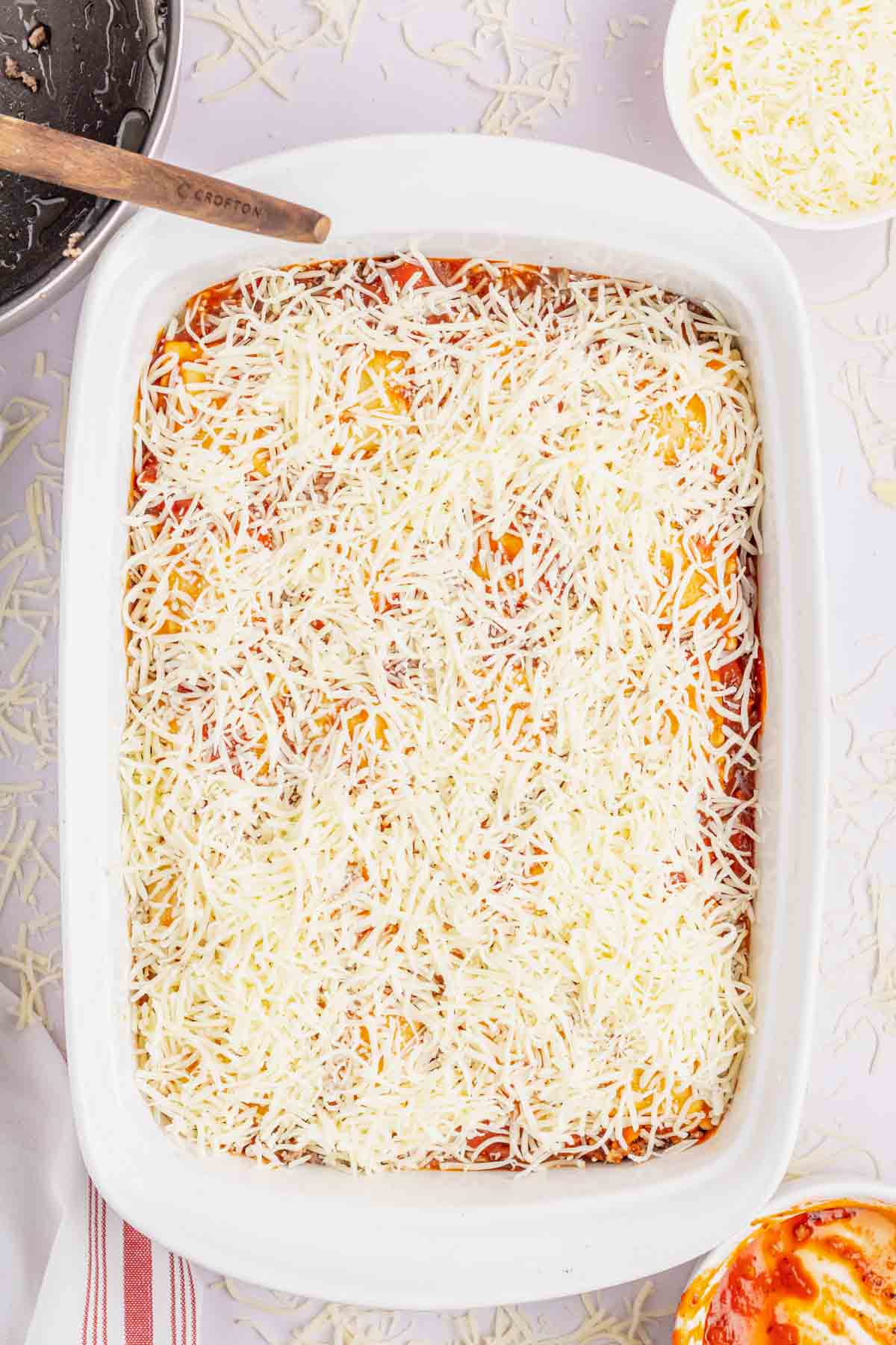 shredded mozzarella on top of ravioli casserole