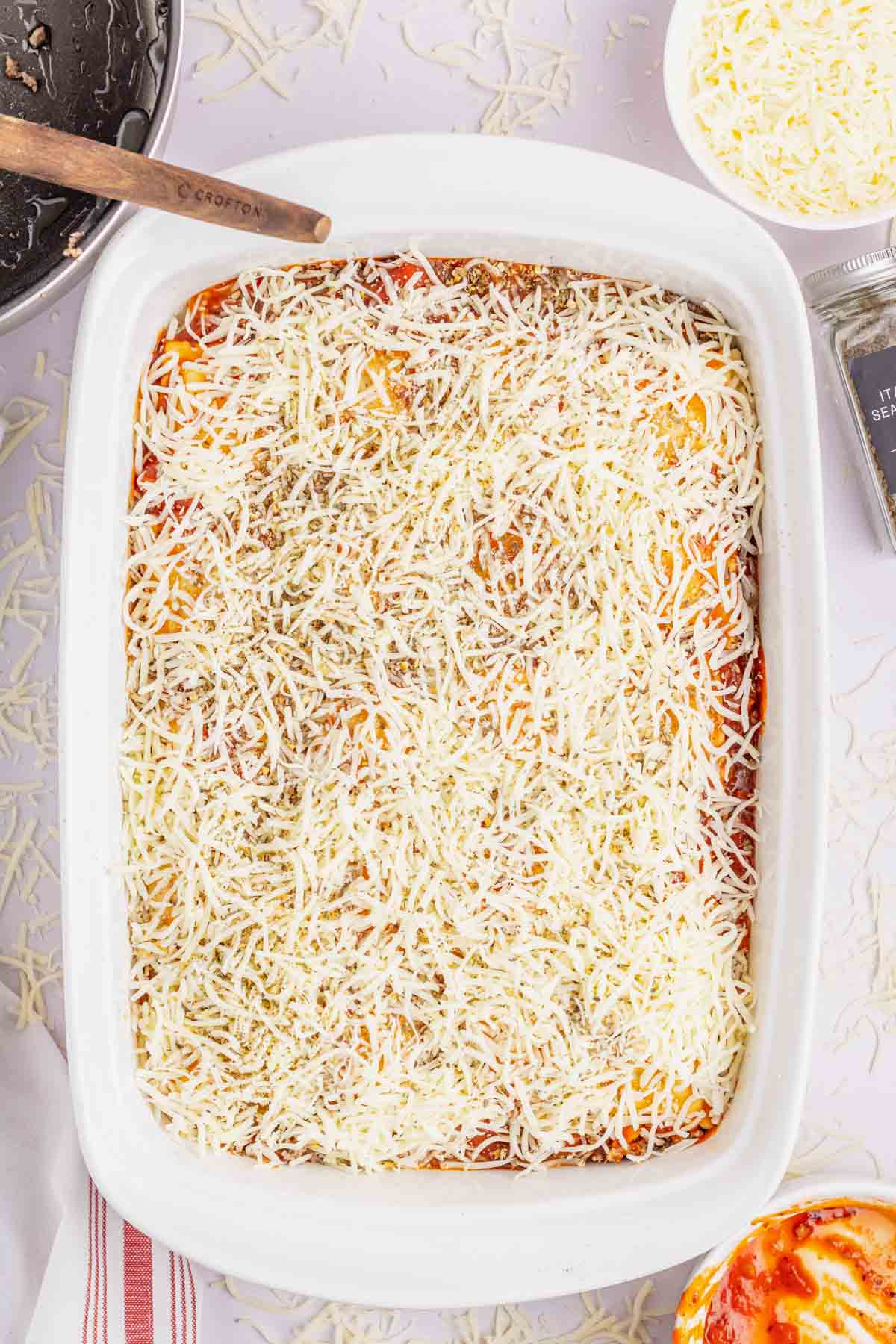 Italian seasoning and shredded mozzarella on top of ravioli casserole