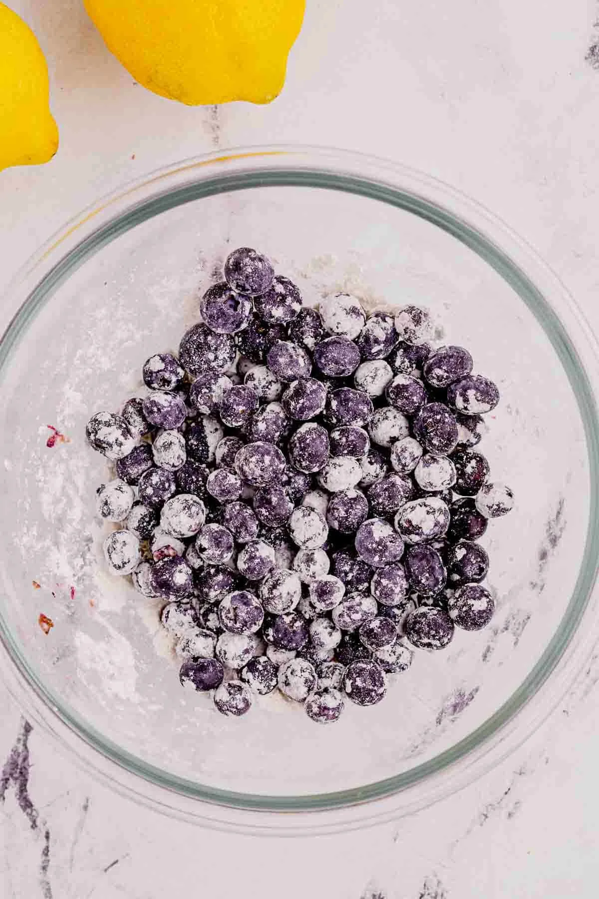flour coated blueberries in a bowl