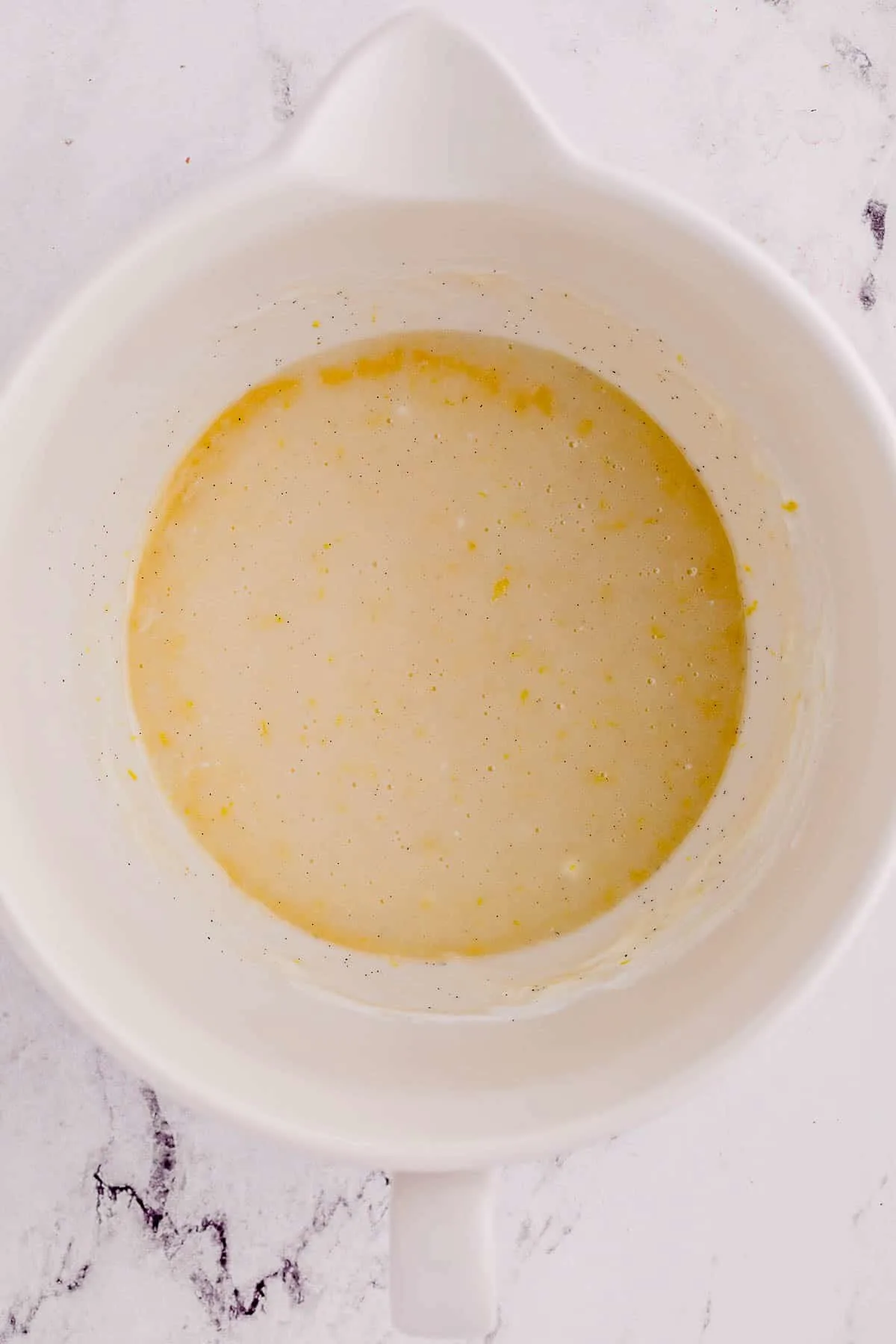 lemon zest, sugar, oil and egg mixture in a bowl