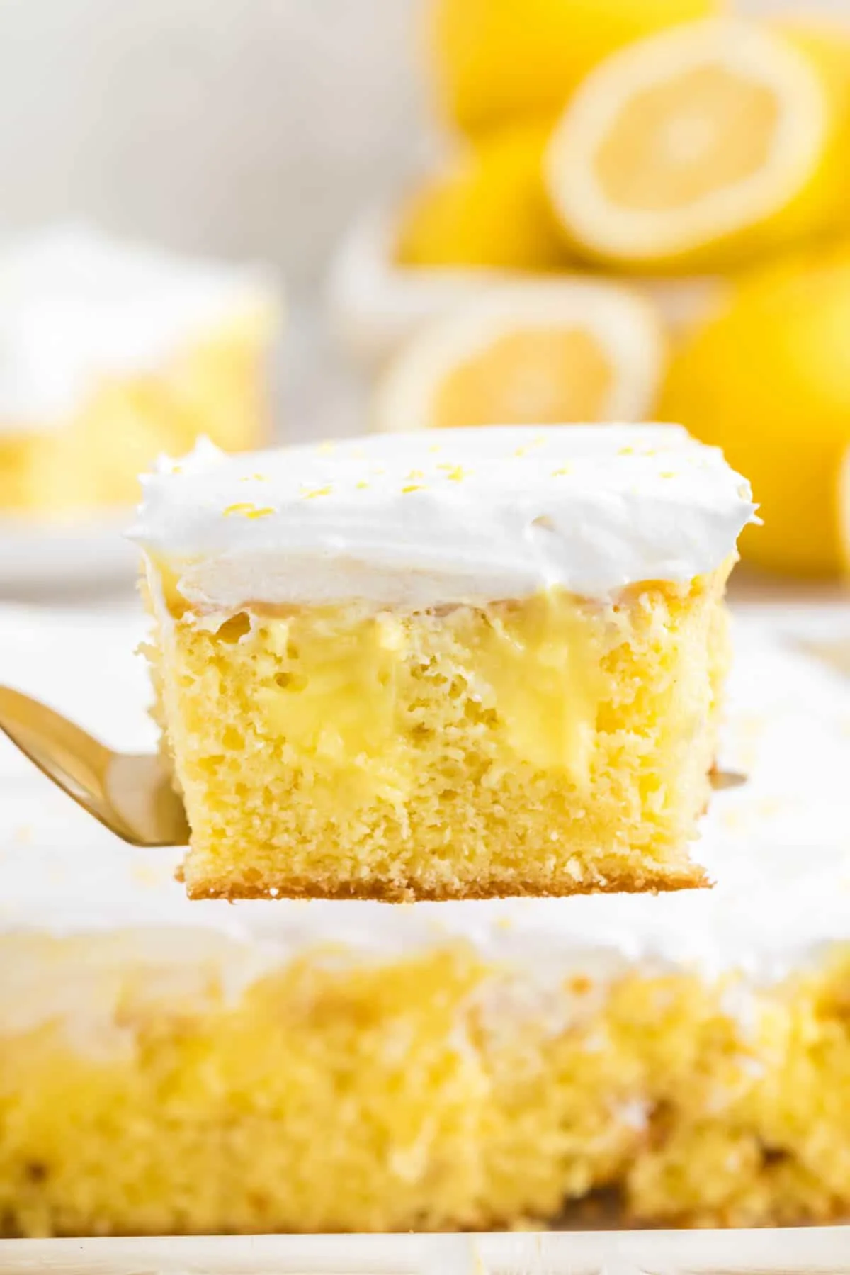 Lemon Poke Cake is a sweety and tangy dessert recipe made with boxed lemon cake mix, lemon instant pudding mix and Cool Whip.