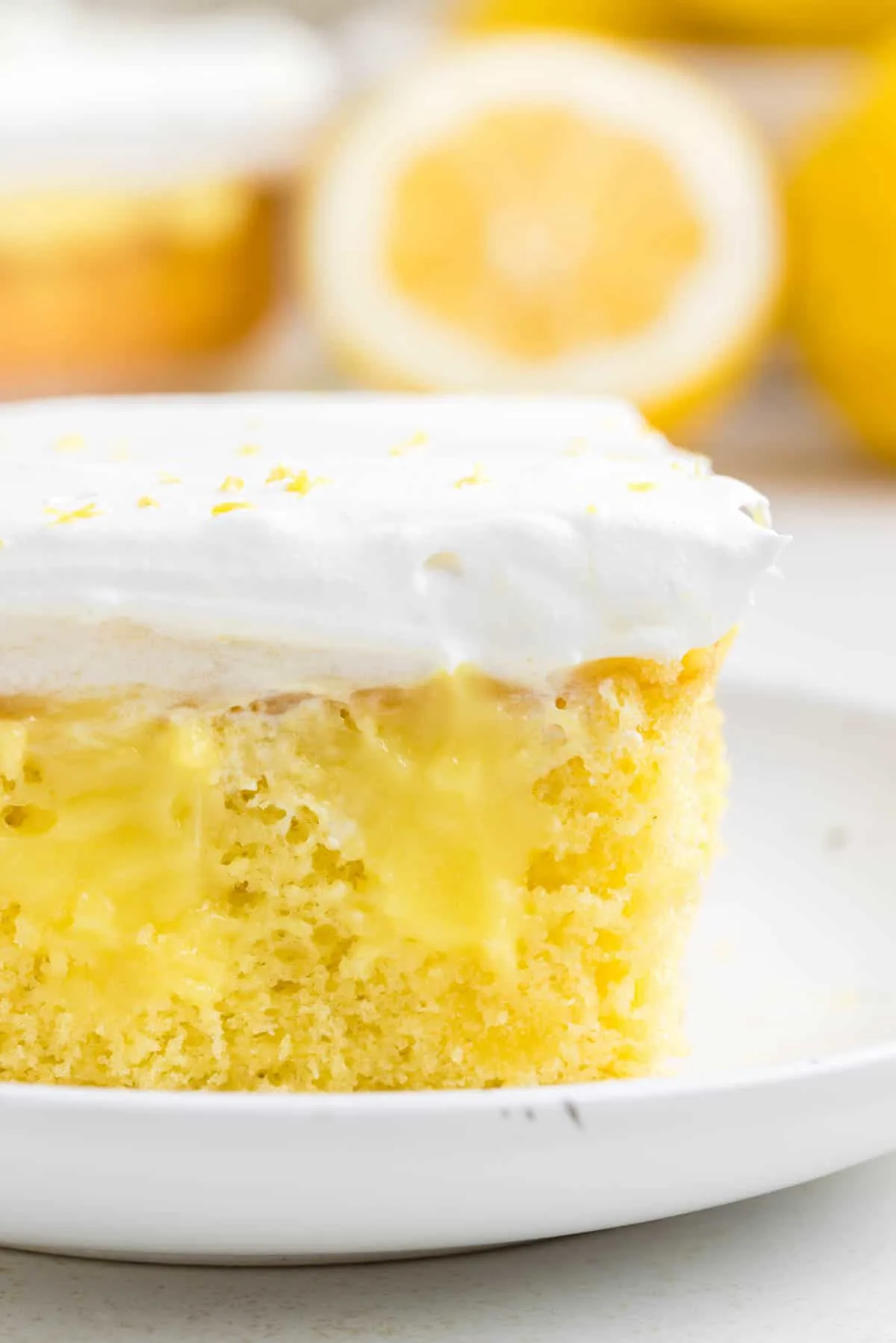 Lemon Poke Cake is a sweety and tangy dessert recipe made with boxed lemon cake mix, lemon instant pudding mix and Cool Whip.