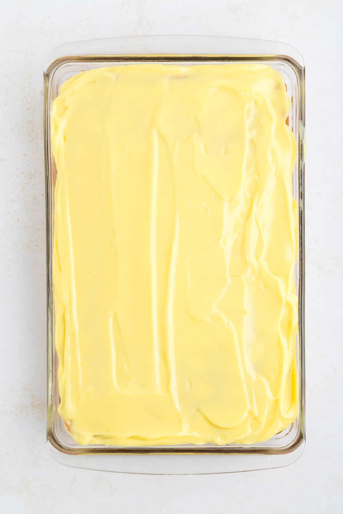lemon pudding spread over lemon cake