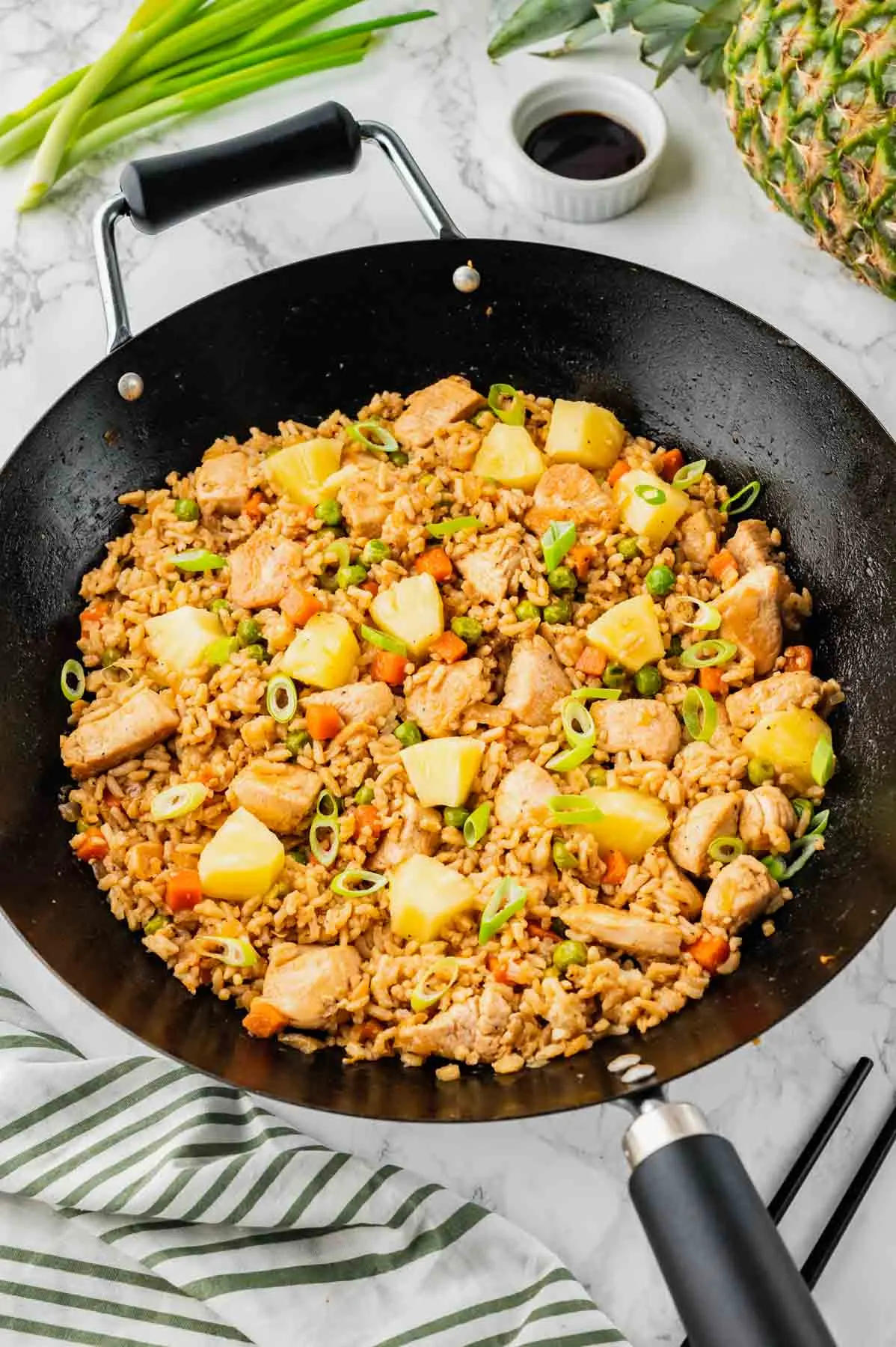 Pineapple Chicken Fried Rice is the perfect balance of sweet and savoury with pineapple chunks, diced chicken breast pieces and rice all seasoned with soy sauce, hoisin sauce and toasted sesame oil.