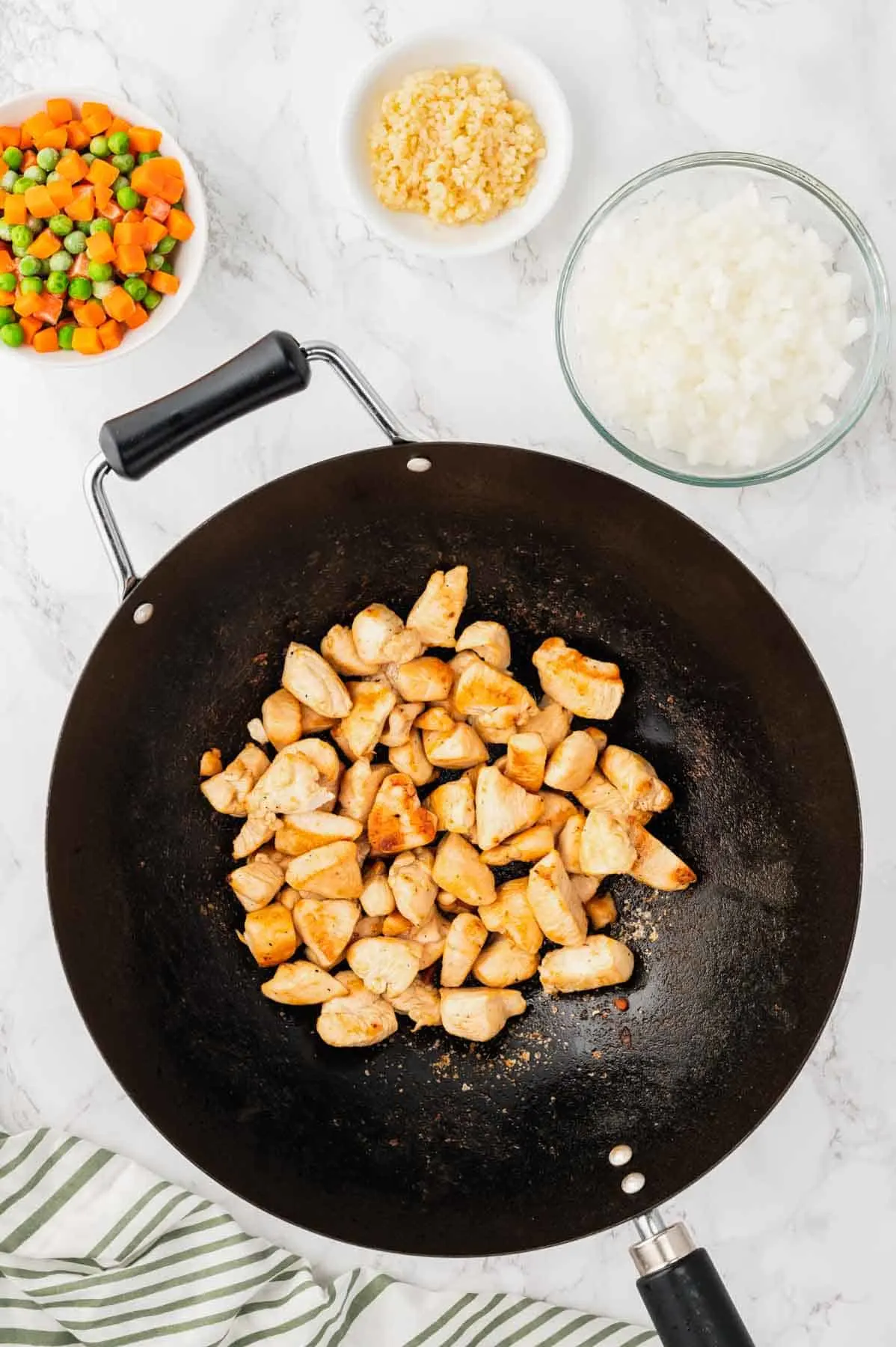 golden brown chicken pieces in a wok