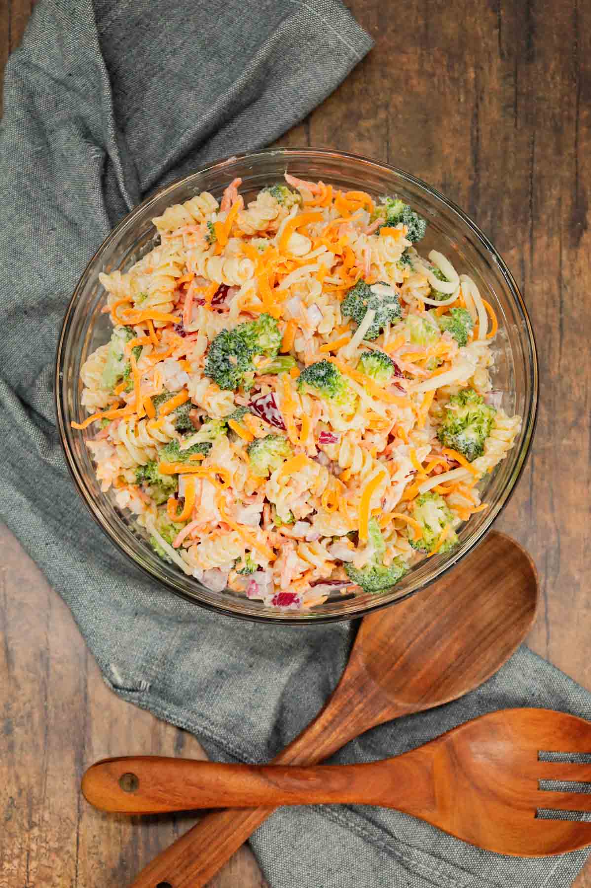 Broccoli Cheddar Pasta Salad is a tasty cold side dish recipe loaded with rotini pasta, broccoli florets, red onions, shredded carrots, cheddar cheese and parmesan all tossed in a mayo and ranch dressing mixture.