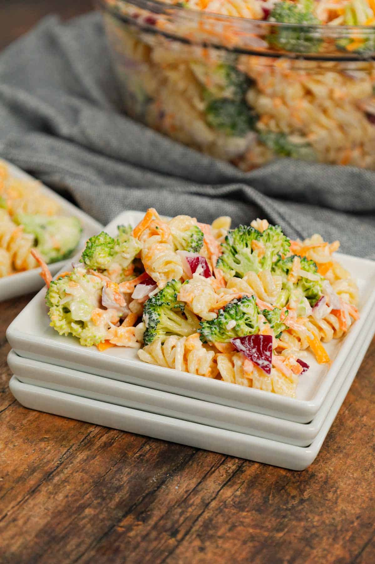 Broccoli Cheddar Pasta Salad is a tasty cold side dish recipe loaded with rotini pasta, broccoli florets, red onions, shredded carrots, cheddar cheese and parmesan all tossed in a mayo and ranch dressing mixture.