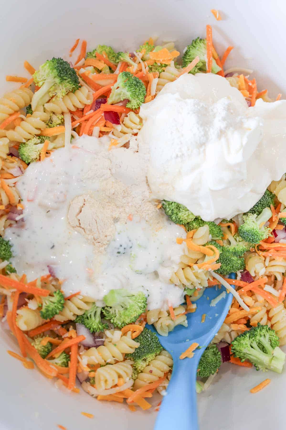 onion powder, garlic powder, mayo and ranch dressing on top of broccoli pasta salad