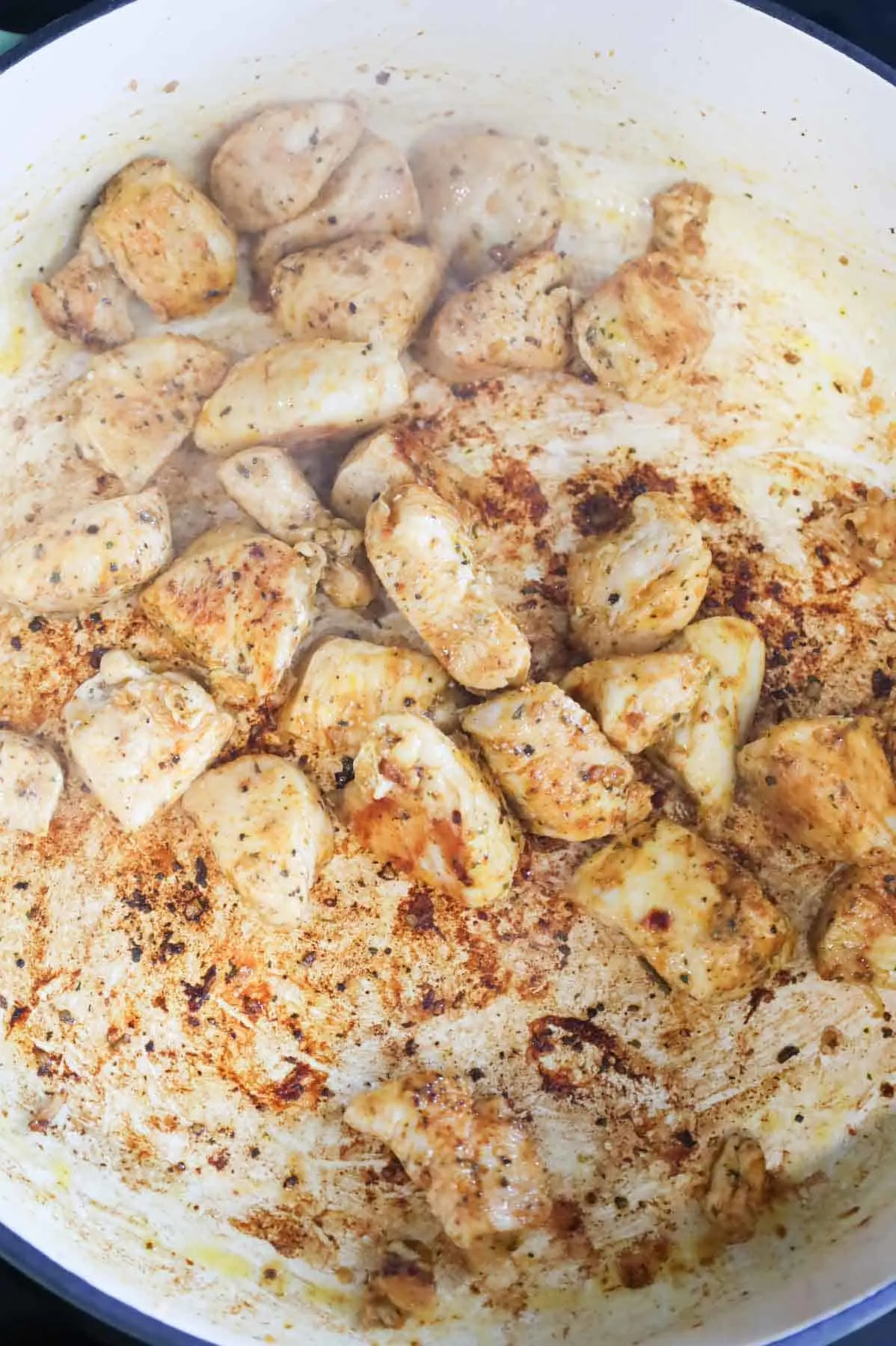 browned chicken breast chunks in a skillet