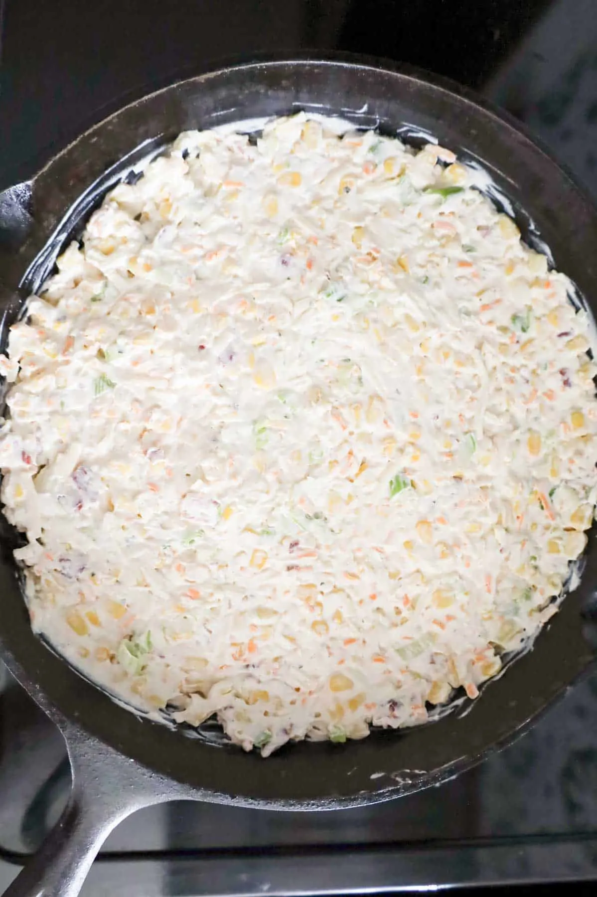 corn dip mixture in a cast iron skillet