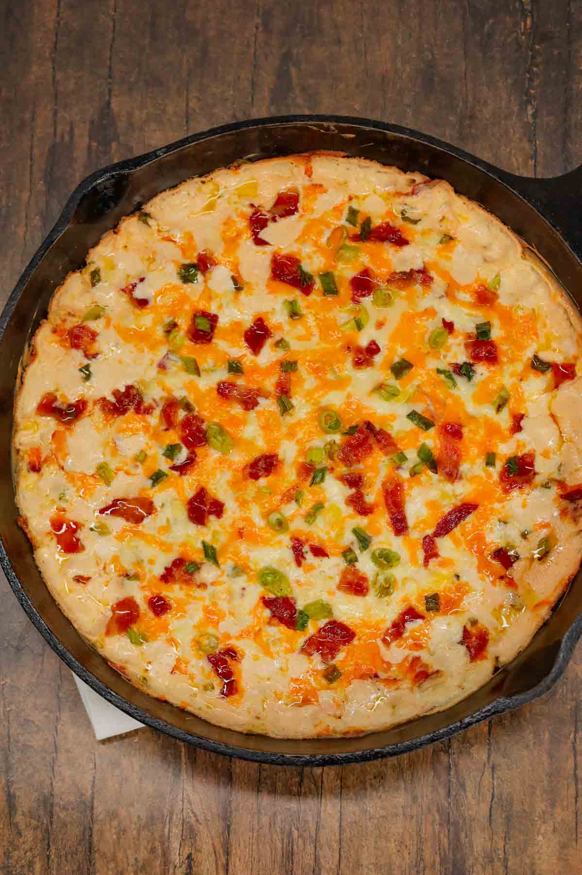 Cracked Out Corn Dip is a delicious hot dip recipe loaded with cream cheese, corn, sour cream, ranch dressing mix, bacon, green onions, cheddar cheese and mozzarella cheese.