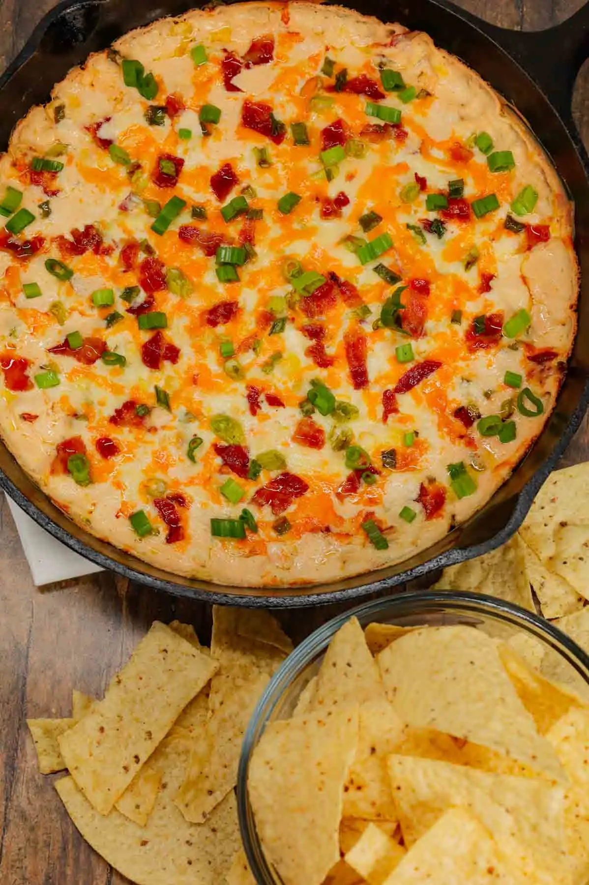 Cracked Out Corn Dip is a delicious hot dip recipe loaded with cream cheese, corn, sour cream, ranch dressing mix, bacon, green onions, cheddar cheese and mozzarella cheese.