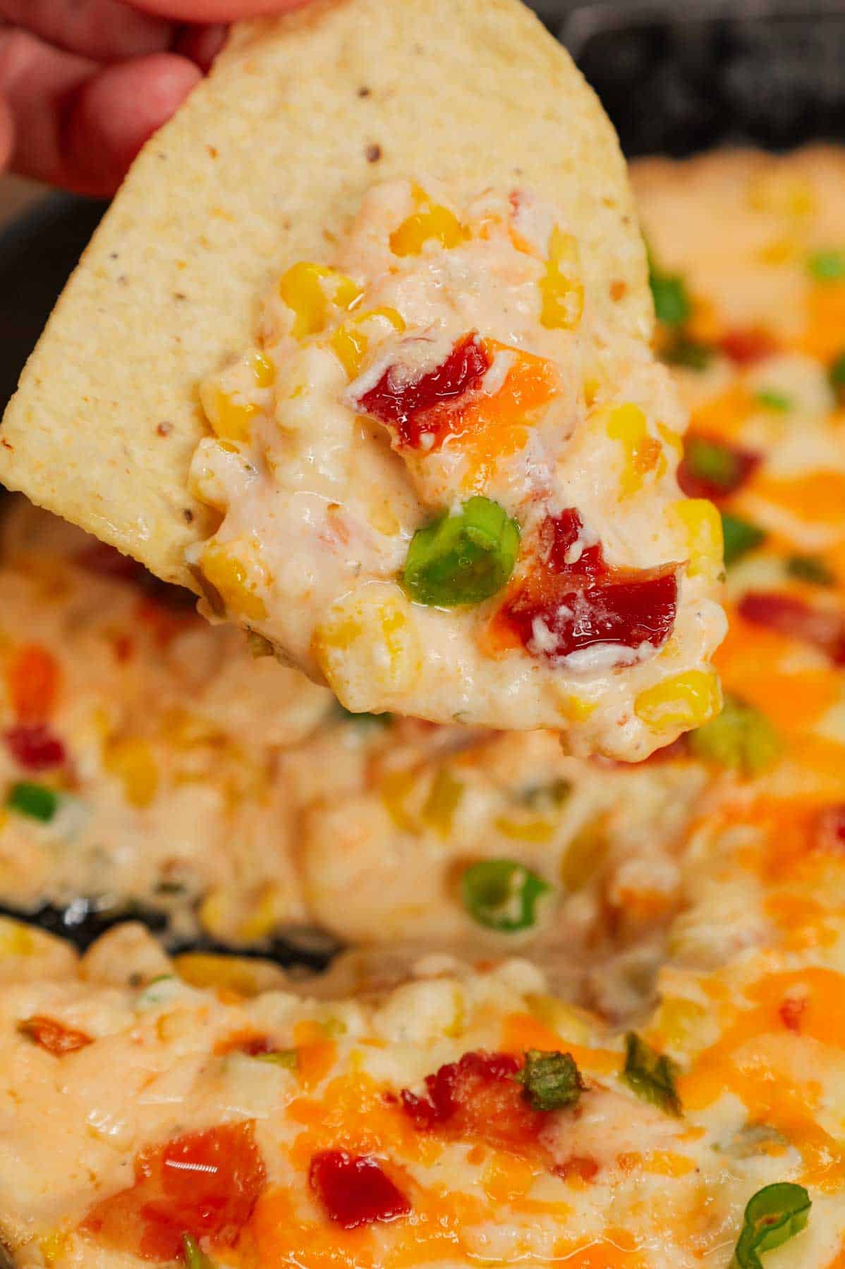 Cracked Out Corn Dip is a delicious hot dip recipe loaded with cream cheese, corn, sour cream, ranch dressing mix, bacon, green onions, cheddar cheese and mozzarella cheese.