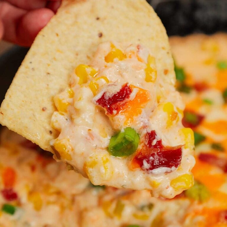 Cracked Out Corn Dip is a delicious hot dip recipe loaded with cream cheese, corn, sour cream, ranch dressing mix, bacon, green onions, cheddar cheese and mozzarella cheese.