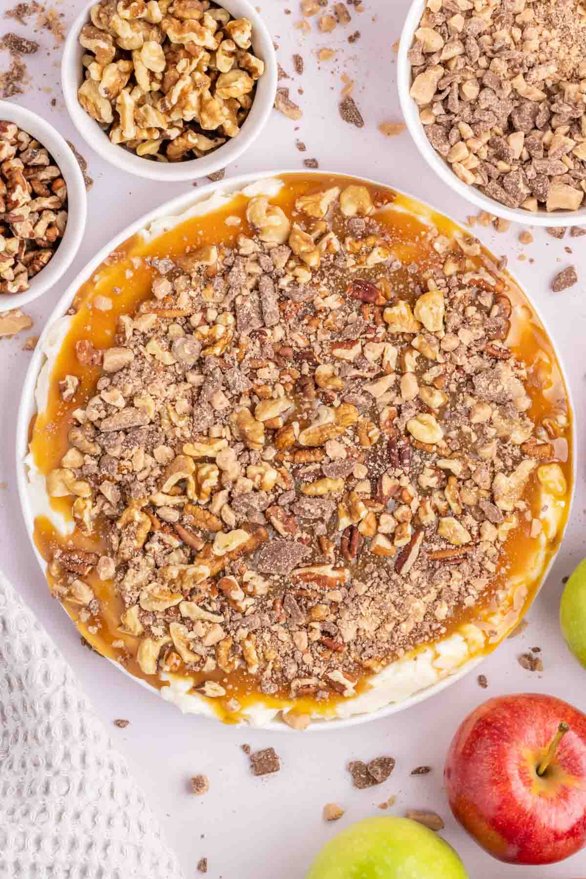 Cream Cheese Caramel Apple Dip is a fun and easy dessert recipe using cream cheese, powdered sugar, caramel sauce, chopped nuts and toffee pieces.