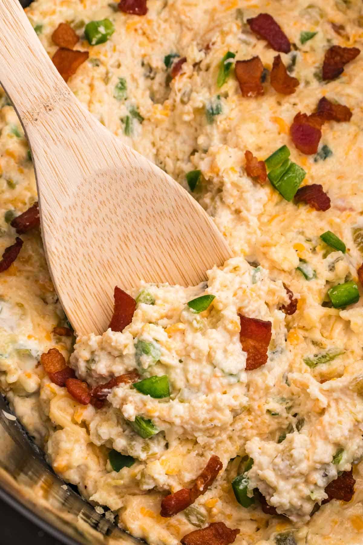 Crock Pot Jalapeno Popper Dip is a delicious hot dip recipe loaded with cream cheese, cheddar, Monterey Jack, mayo, sour cream, jalapenos, green chilies, parmesan, panko bread crumbs and bacon.