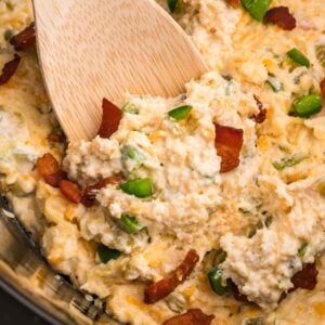 Crock Pot Jalapeno Popper Dip is a delicious hot dip recipe loaded with cream cheese, cheddar, Monterey Jack, mayo, sour cream, jalapenos, green chilies, parmesan, panko bread crumbs and bacon.