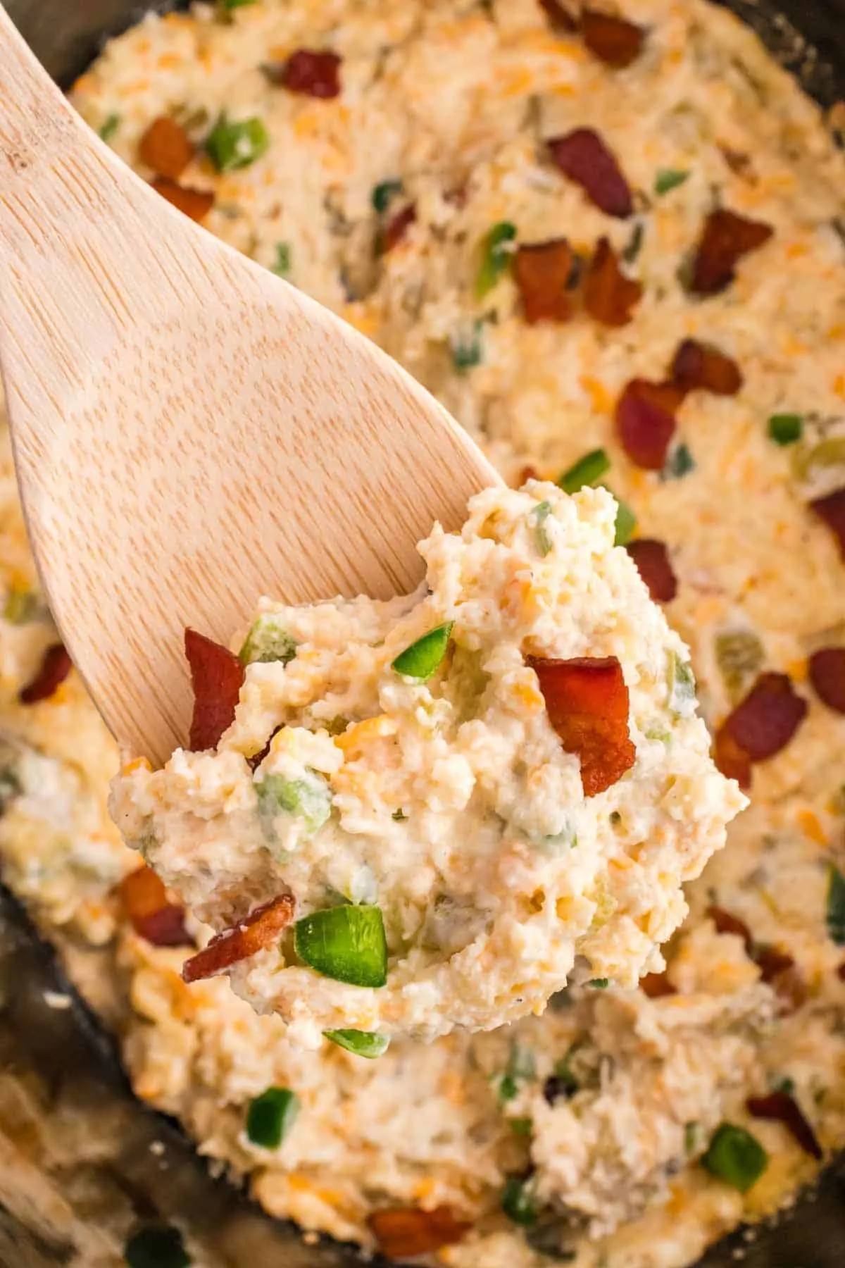Crock Pot Jalapeno Popper Dip is a delicious hot dip recipe loaded with cream cheese, cheddar, Monterey Jack, mayo, sour cream, jalapenos, green chilies, parmesan, panko bread crumbs and bacon.