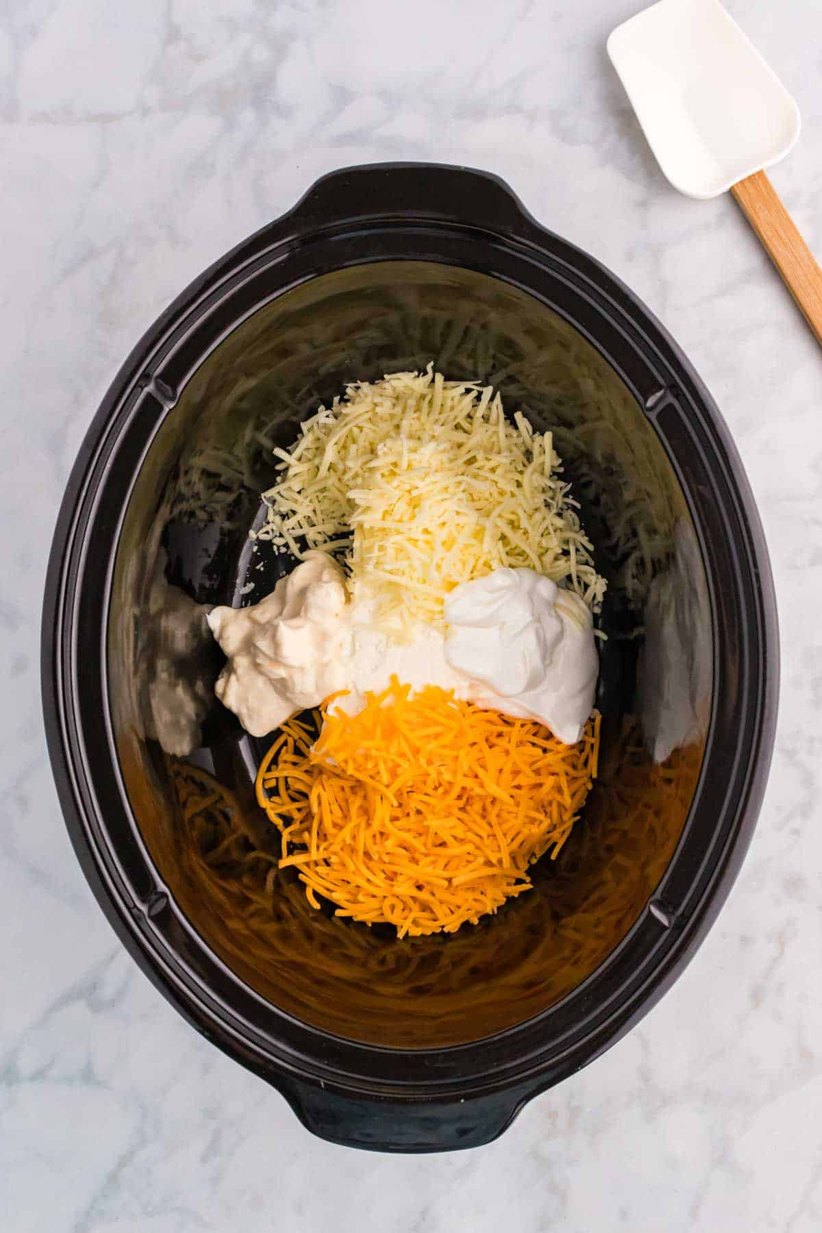 shredded cheddar, Monterey jack, sour cream, mayo and cream cheese in a Crock Pot