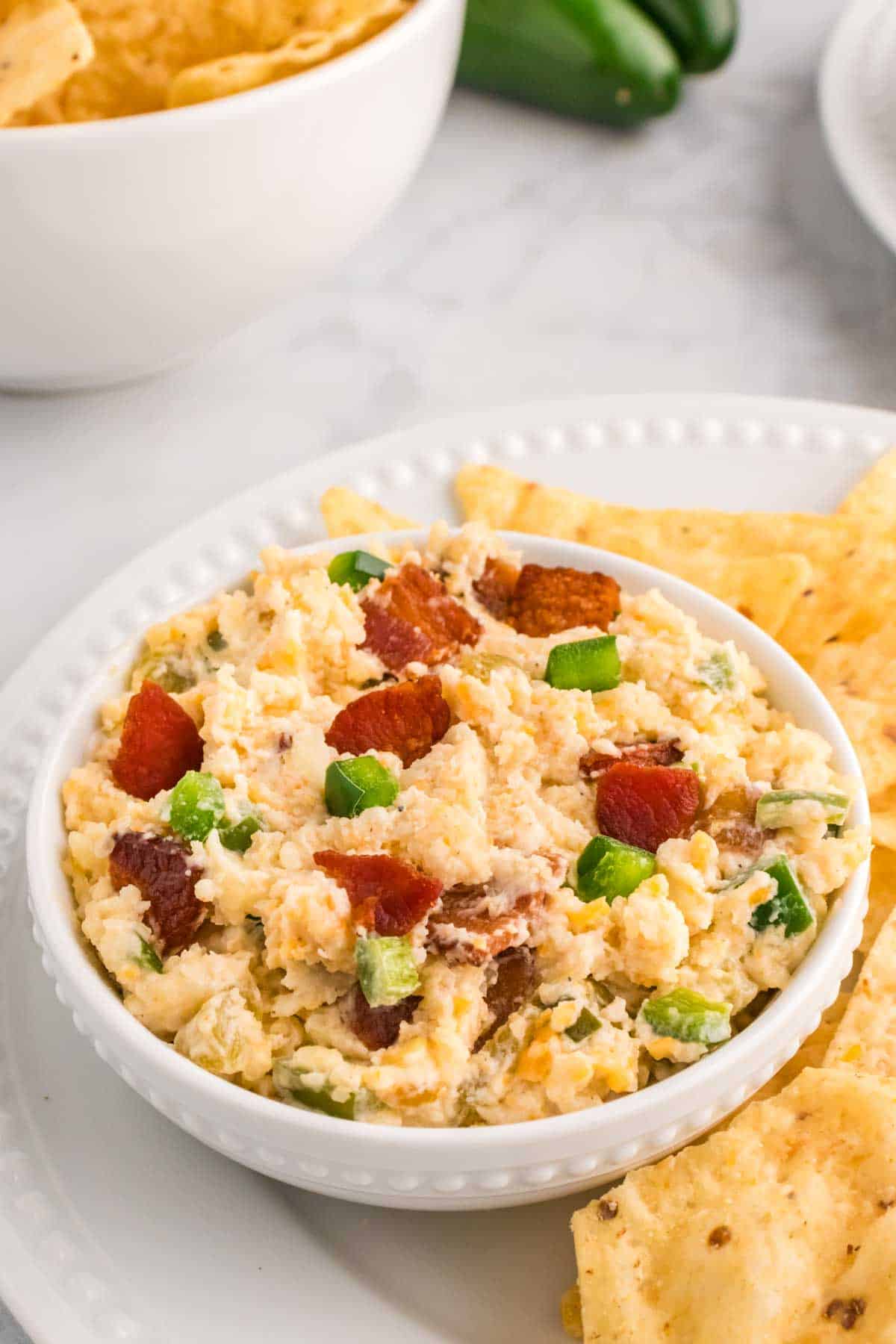 Crock Pot Jalapeno Popper Dip is a delicious hot dip recipe loaded with cream cheese, cheddar, Monterey Jack, mayo, sour cream, jalapenos, green chilies, parmesan, panko bread crumbs and bacon.