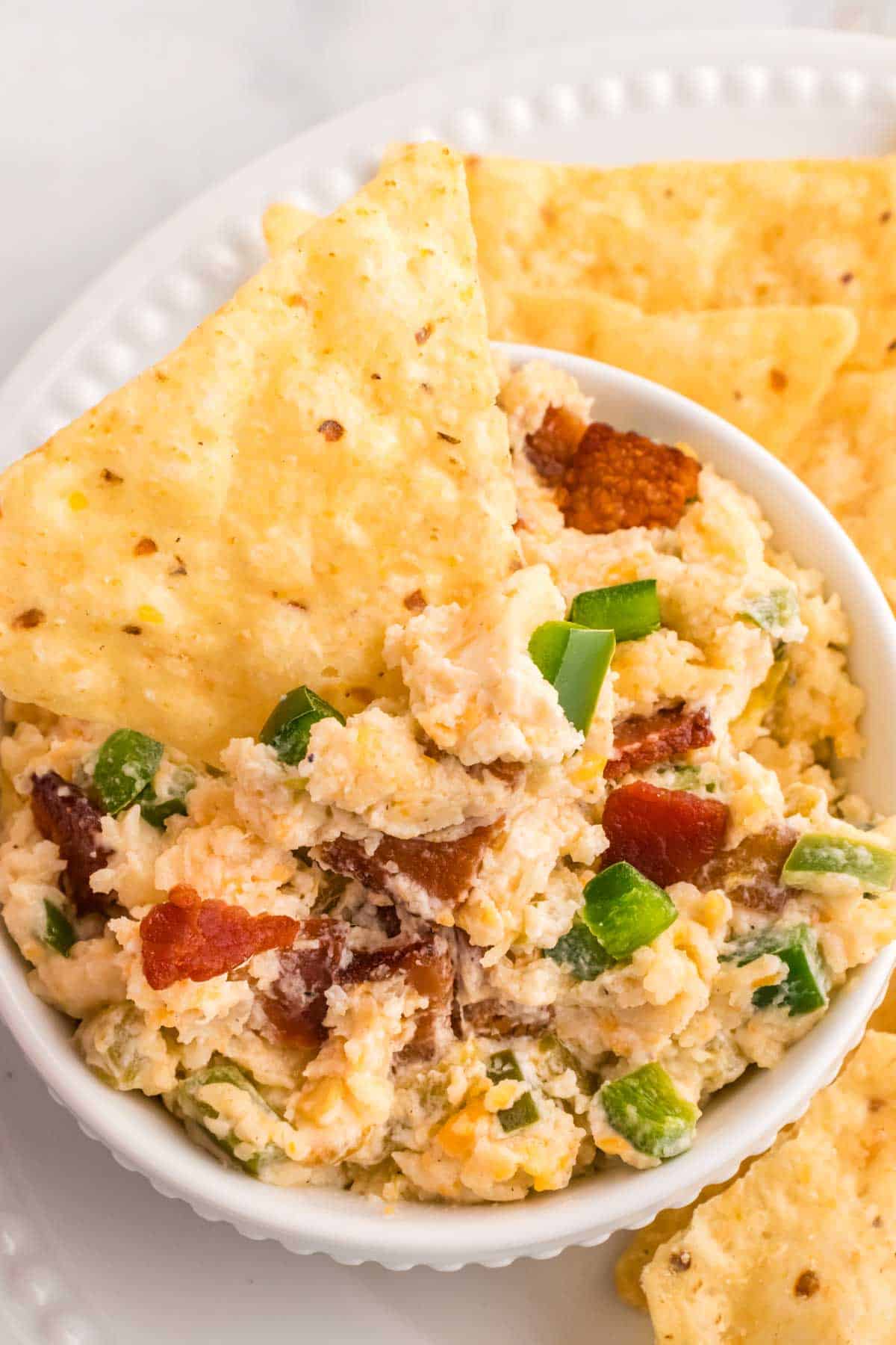 Crock Pot Jalapeno Popper Dip is a delicious hot dip recipe loaded with cream cheese, cheddar, Monterey Jack, mayo, sour cream, jalapenos, green chilies, parmesan, panko bread crumbs and bacon.