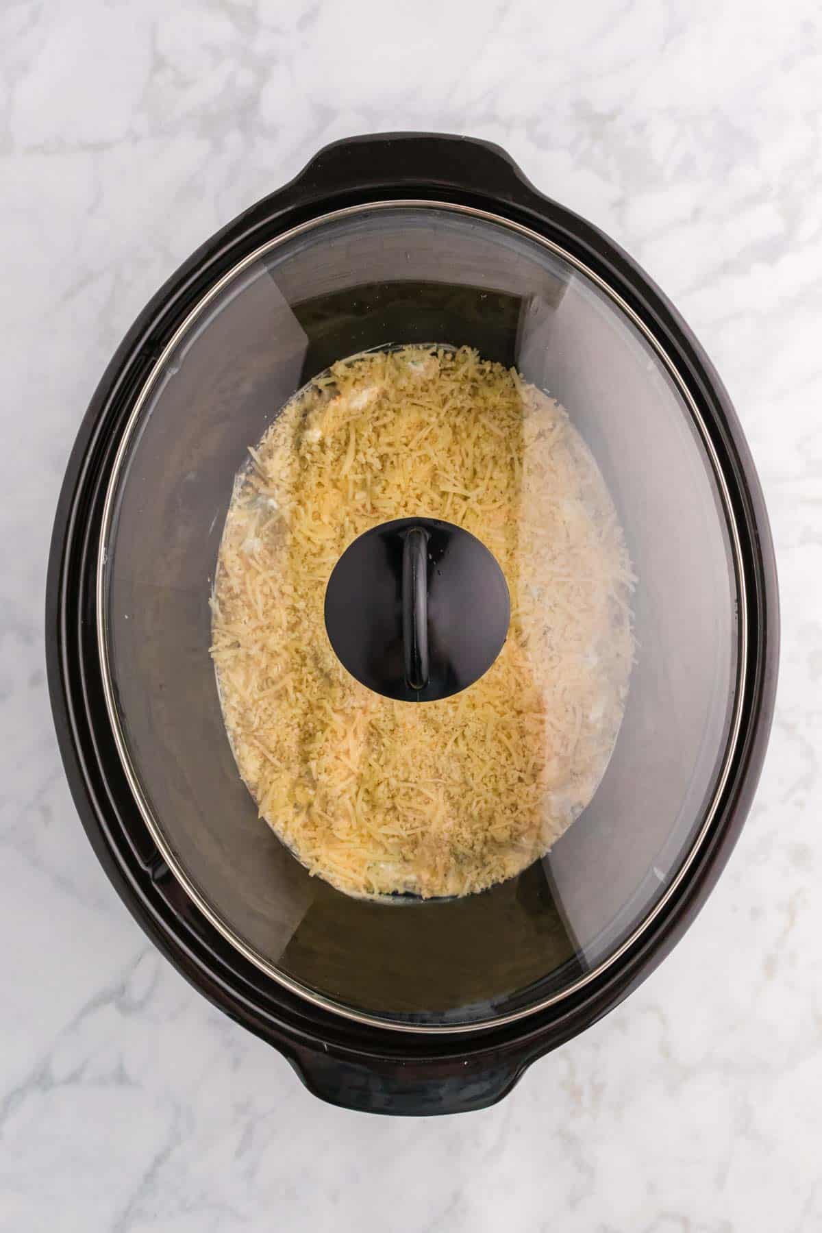 lid on crock pot containing jalapeno popper dip