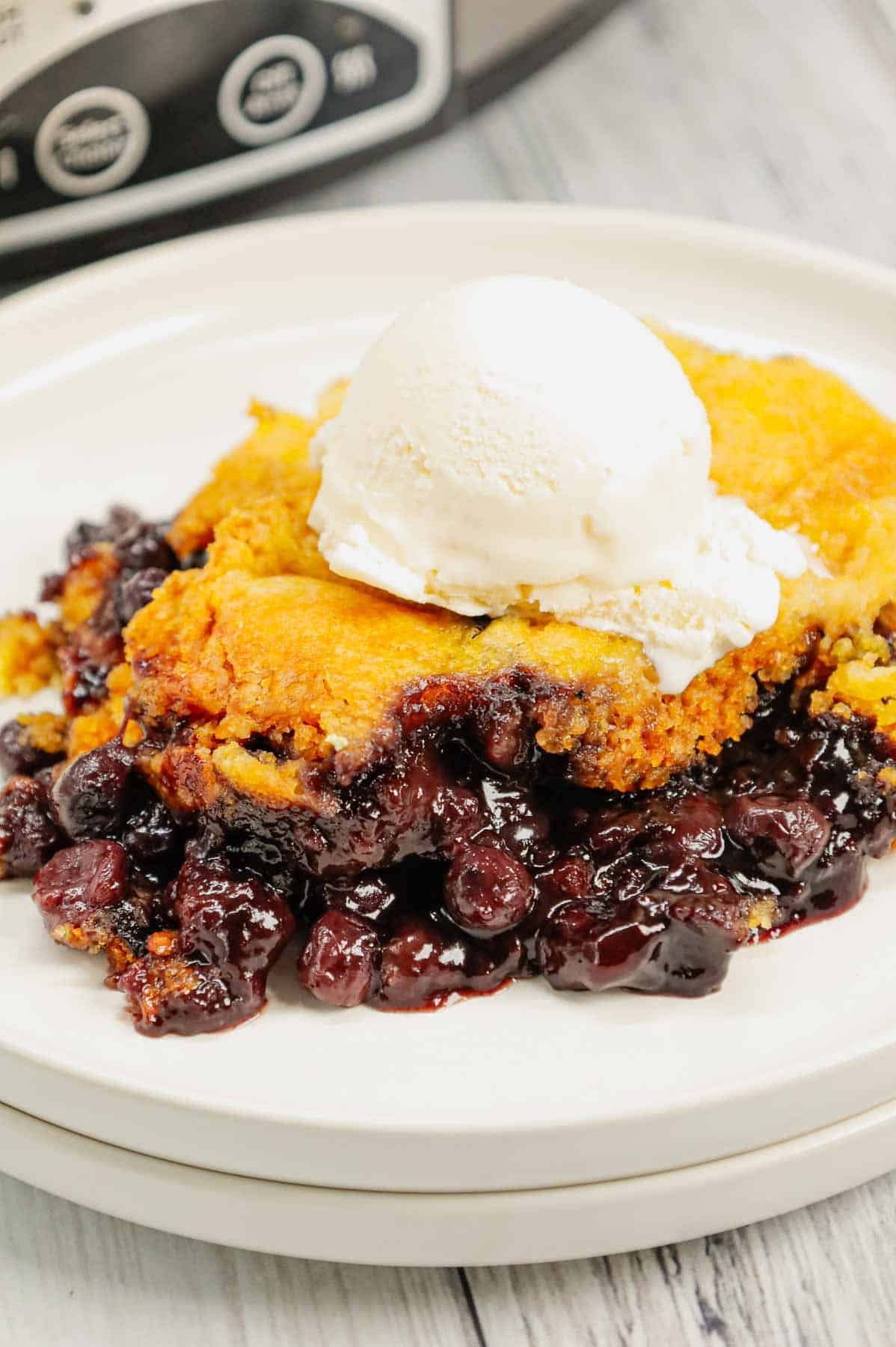 Crock Pot Lemon Blueberry Cobbler is an easy slow cooker dessert recipe using frozen blueberries, lemon pudding mix, sugar, boxed lemon cake mix and butter.