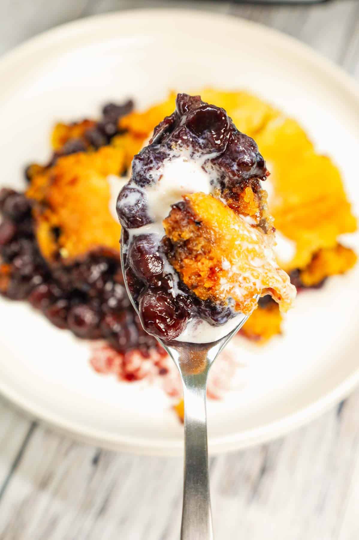 Crock Pot Lemon Blueberry Cobbler is an easy slow cooker dessert recipe using frozen blueberries, lemon pudding mix, sugar, boxed lemon cake mix and butter.