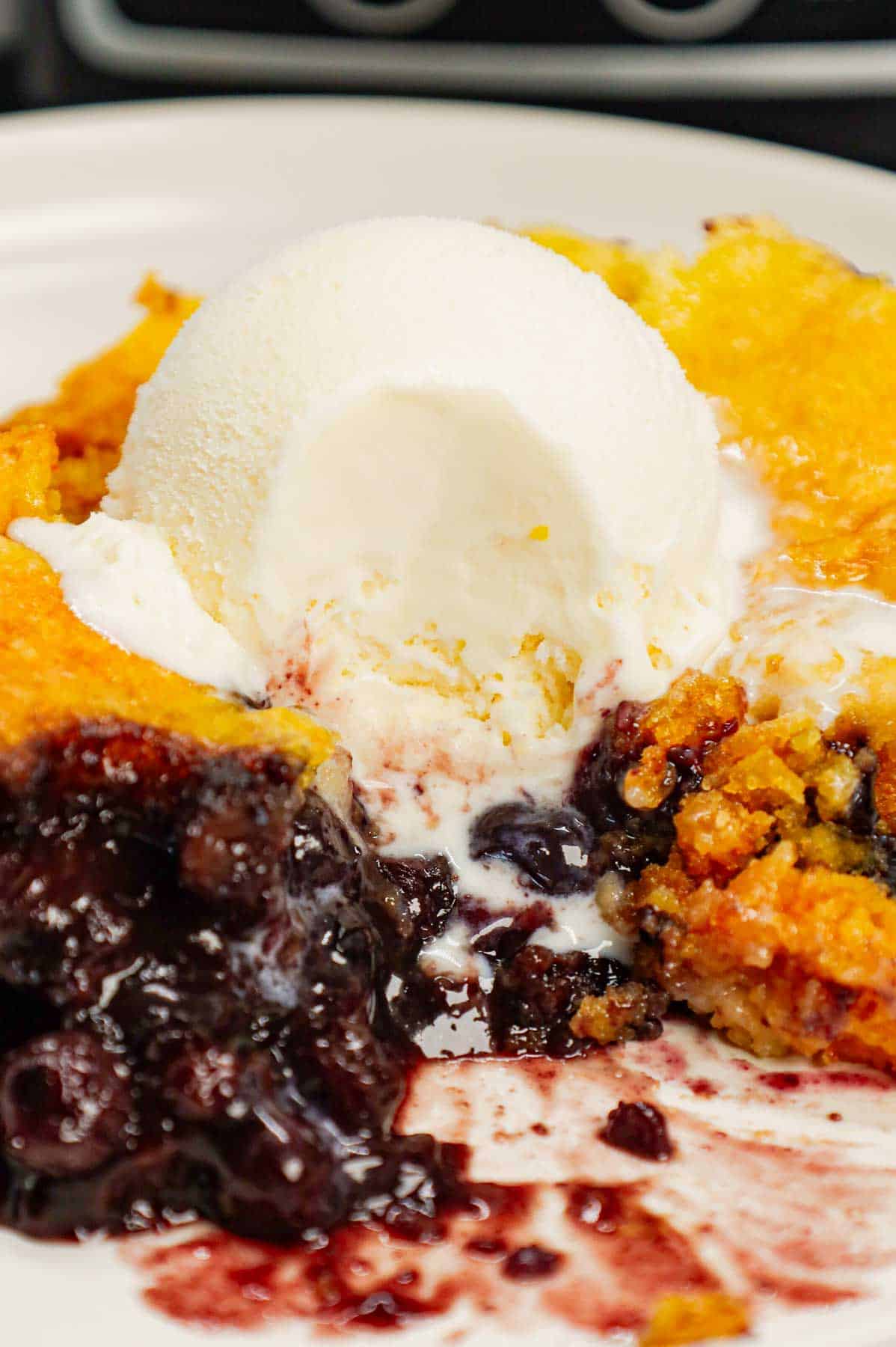 Crock Pot Lemon Blueberry Cobbler is an easy slow cooker dessert recipe using frozen blueberries, lemon pudding mix, sugar, boxed lemon cake mix and butter.