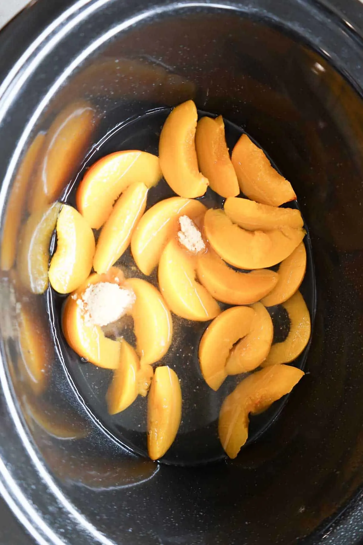 brown sugar on top of canned peach slices in a crock pot