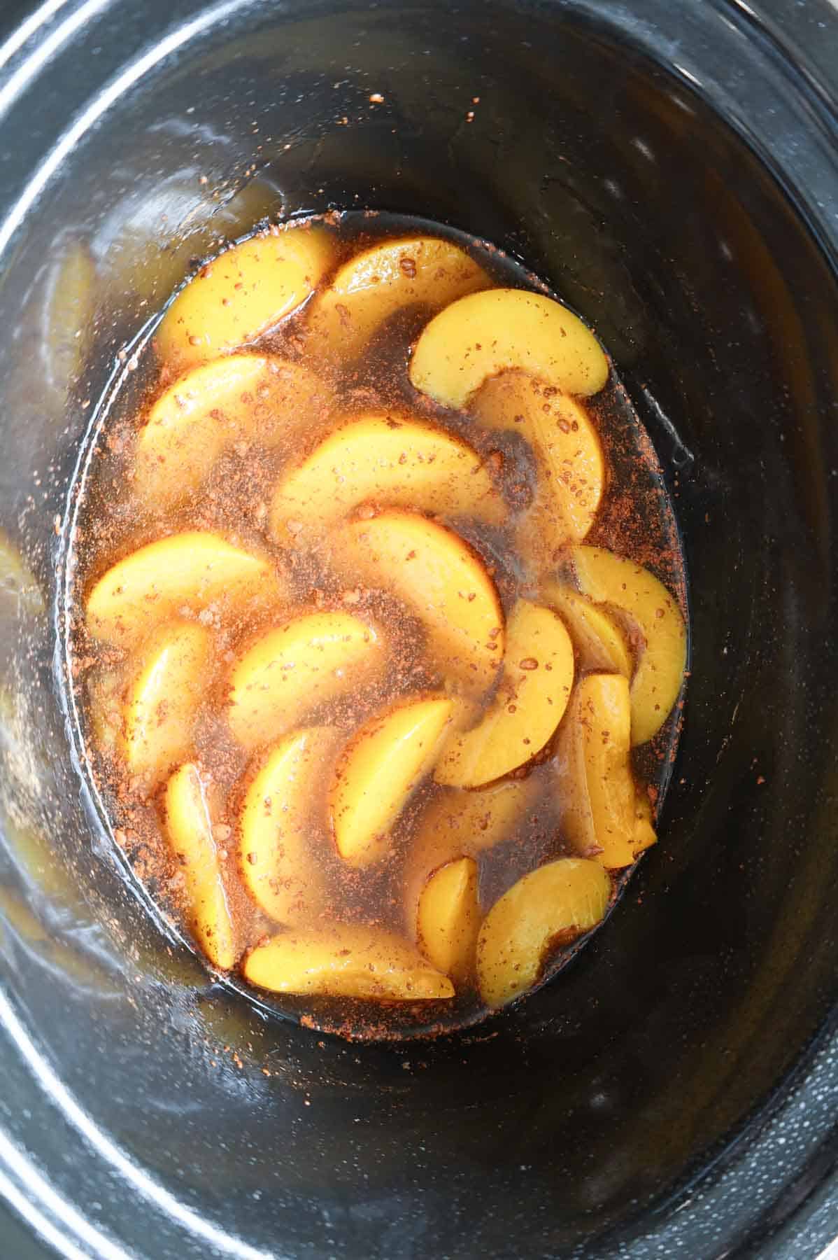 sliced peaches, brown sugar and cinnamon mixture in a crock pot
