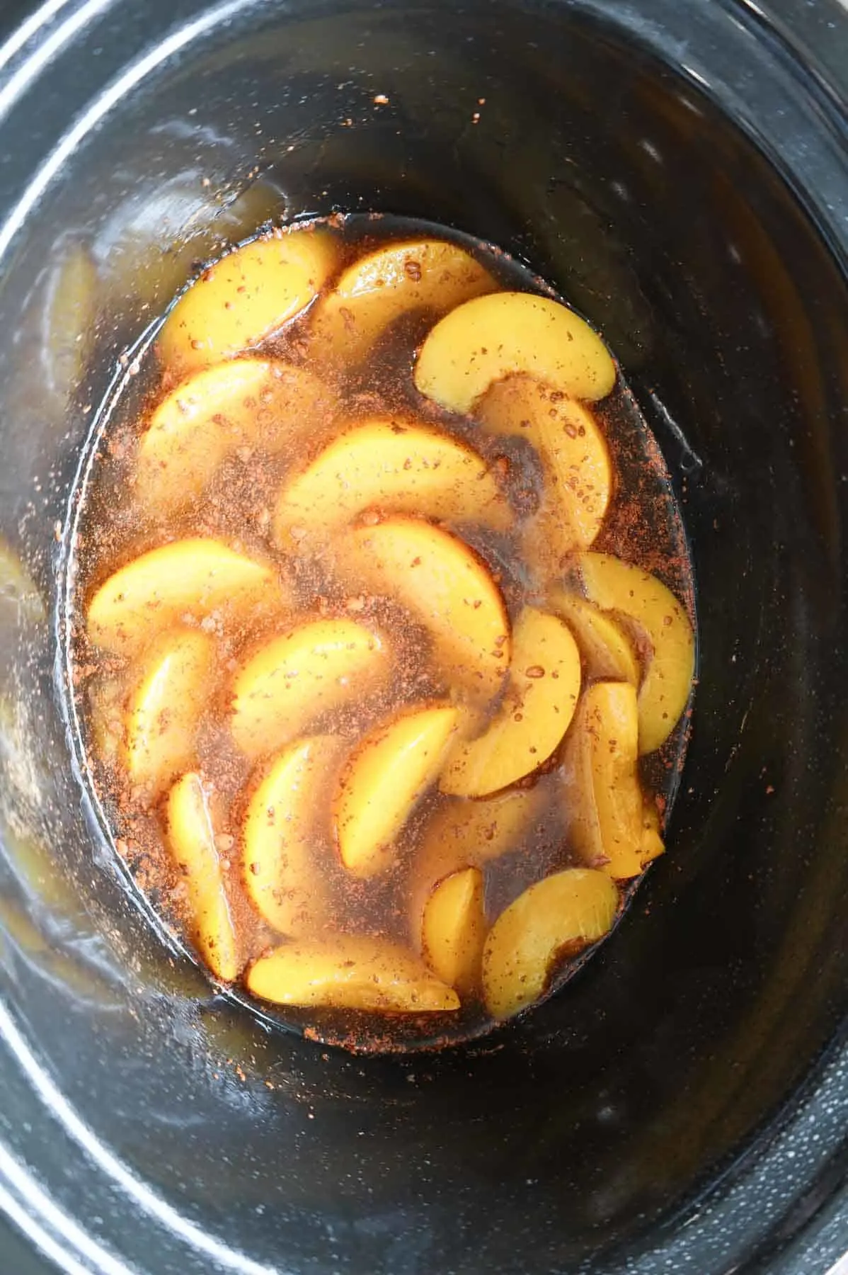 sliced peaches, brown sugar and cinnamon mixture in a crock pot