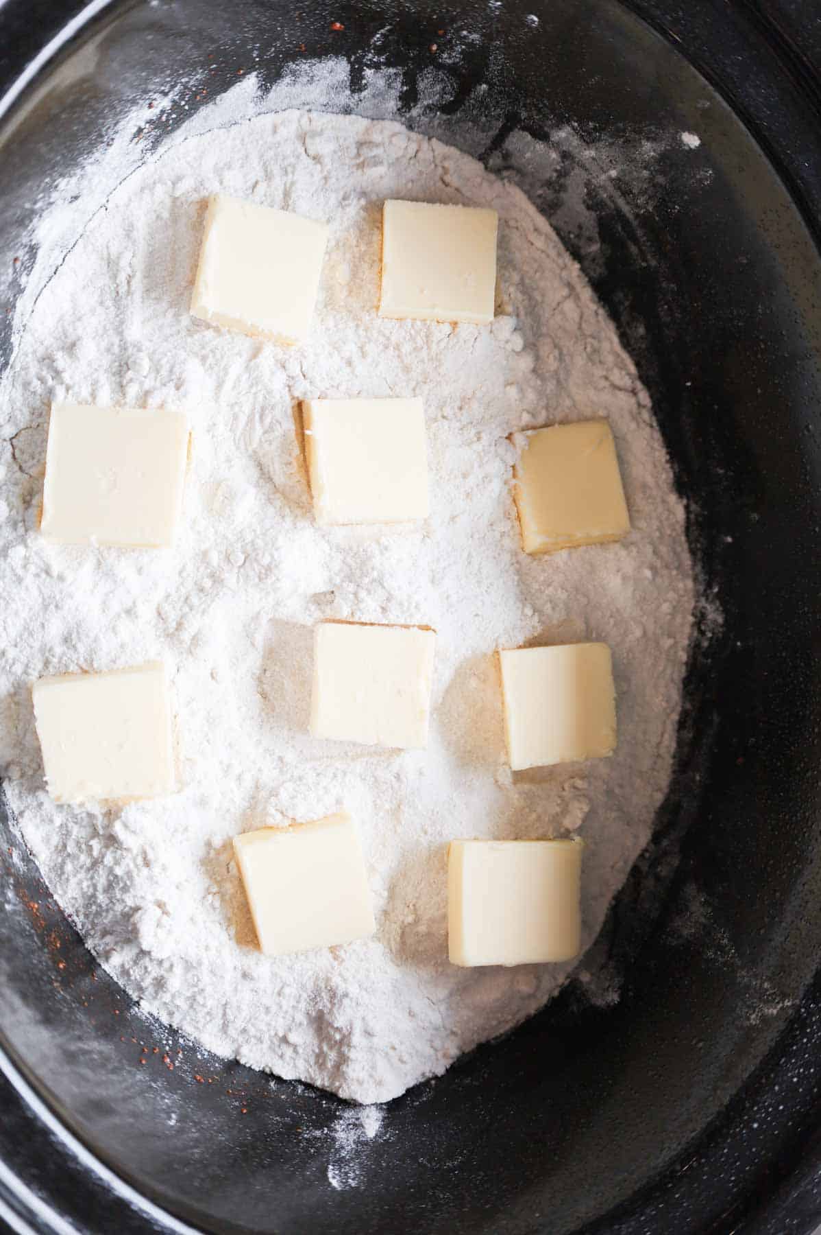 butter squares on top of cake mix in a crock pot