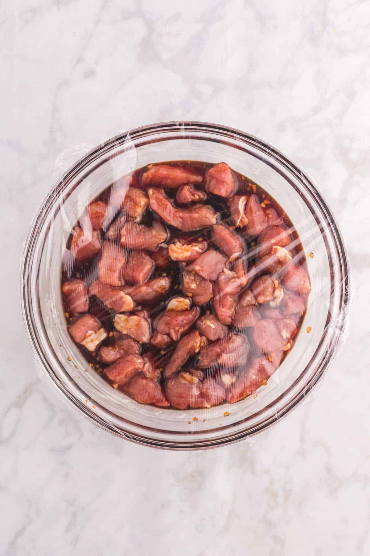 pork pieces marinating in a bowl