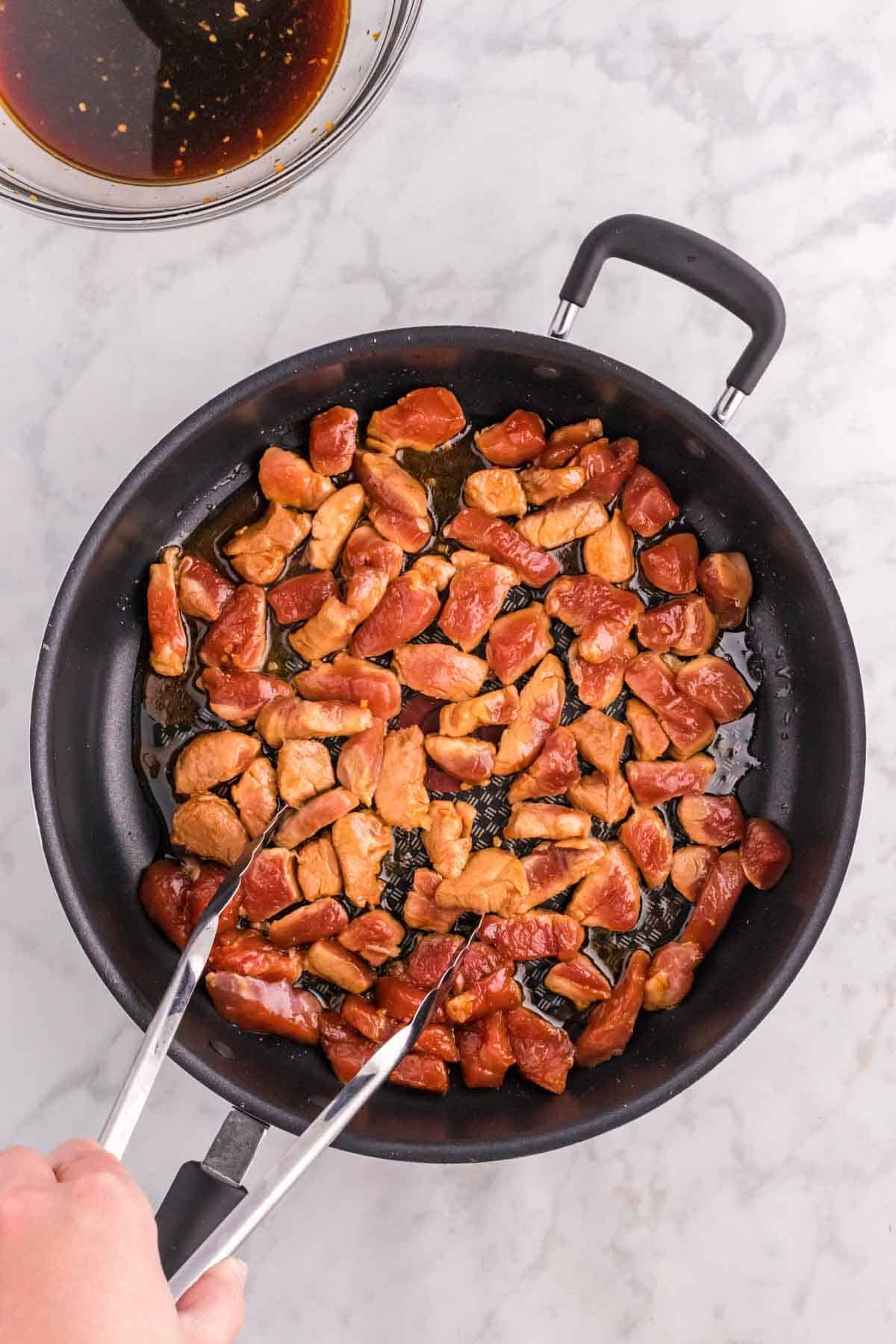browned pork pieces in a skillet
