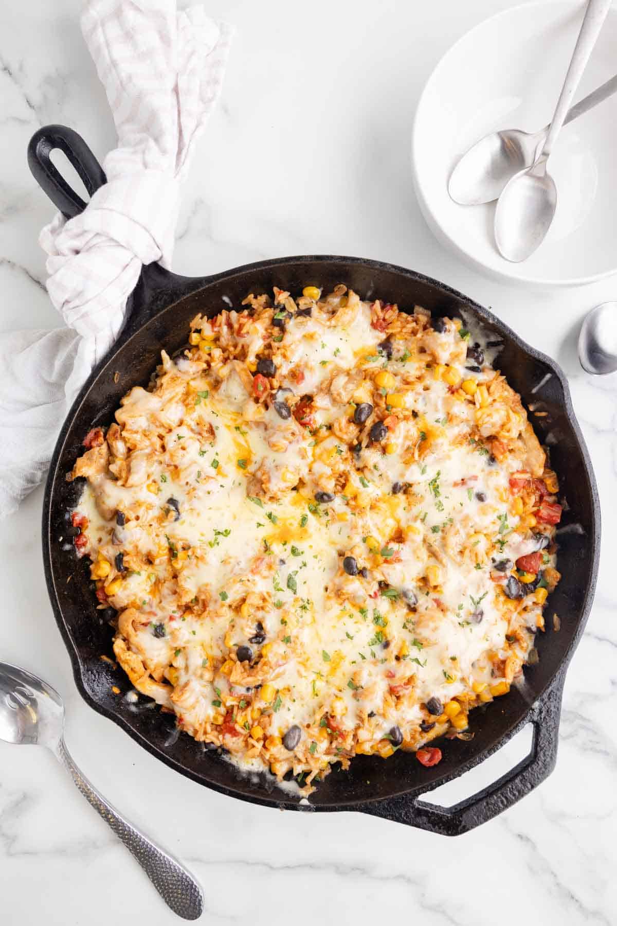 One Pan Cheesy Taco Chicken and Rice is an easy stove top dinner recipe loaded with chicken thigh chunks, Rotel, corn, black beans, taco seasoning, rice and shredded cheese.