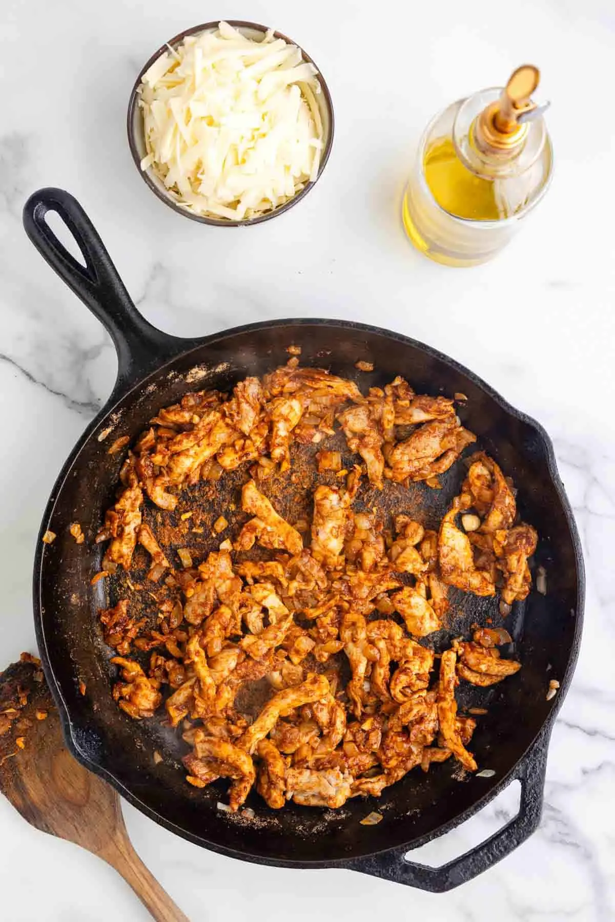taco seasoning coated chicken pieces in a skillet