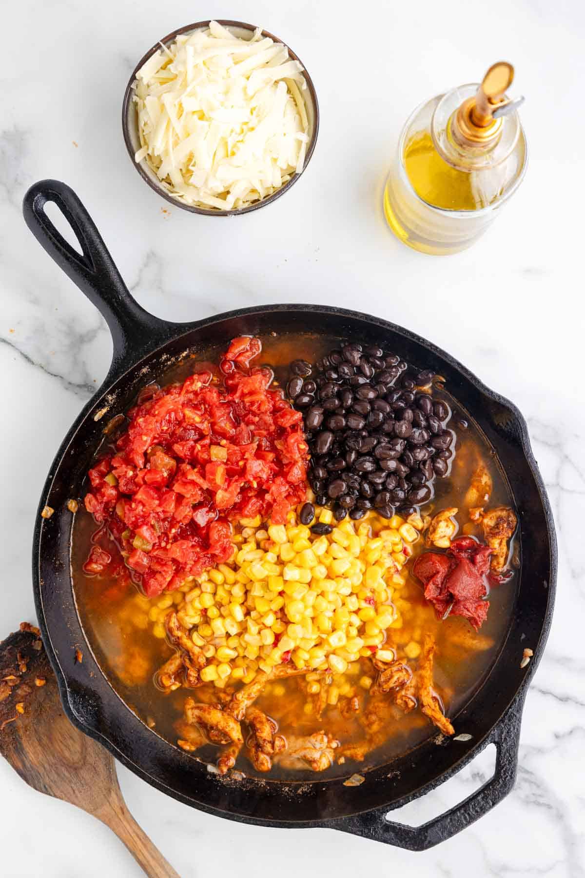 Rotel, corn and black beans added to skillet with broth and chicken mixture