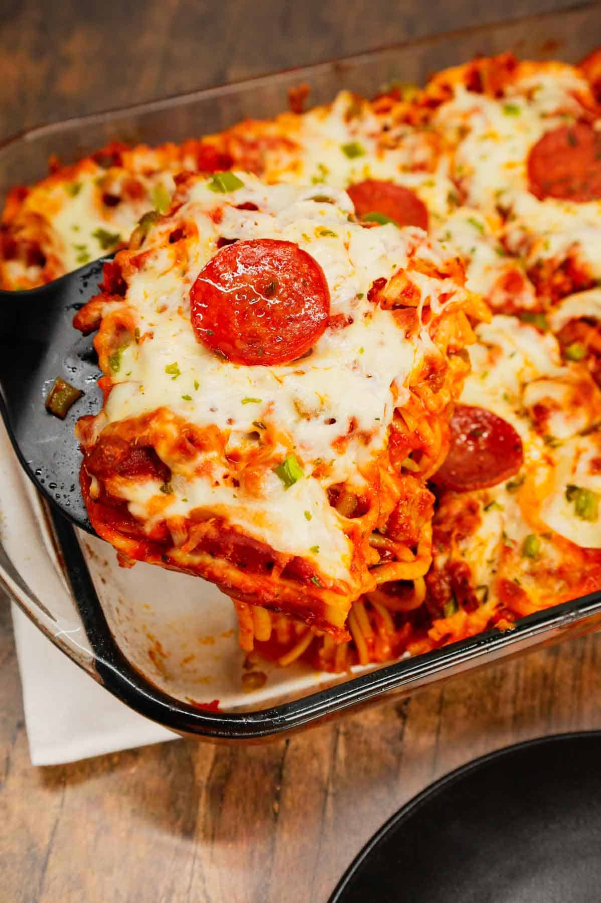 Pizza Baked Spaghetti is a hearty spaghetti recipe loaded with Italian sausage, pepperoni, green bell peppers, pizza sauce, marinara and mozzarella cheese.
