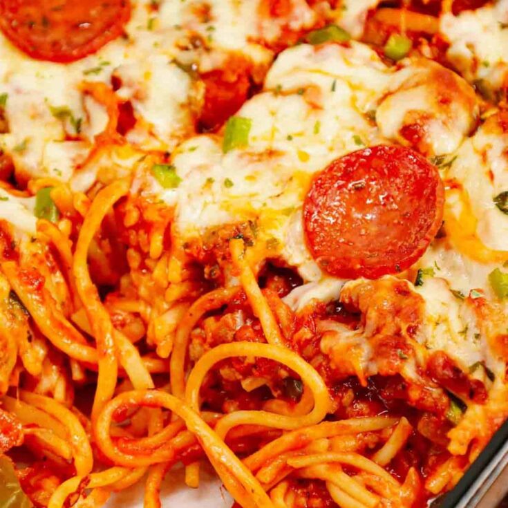 Pizza Baked Spaghetti is a hearty spaghetti recipe loaded with Italian sausage, pepperoni, green bell peppers, pizza sauce, marinara and mozzarella cheese.