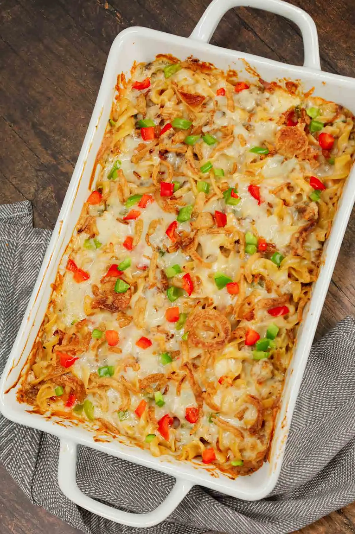 Sausage and Noodle Casserole is a hearty dinner recipe loaded with Italian sausage meat, egg noodle and diced bell peppers all tossed in a cream of mushroom and cream cheese mixture and baked with provolone cheese and French's crispy fried onions on top.