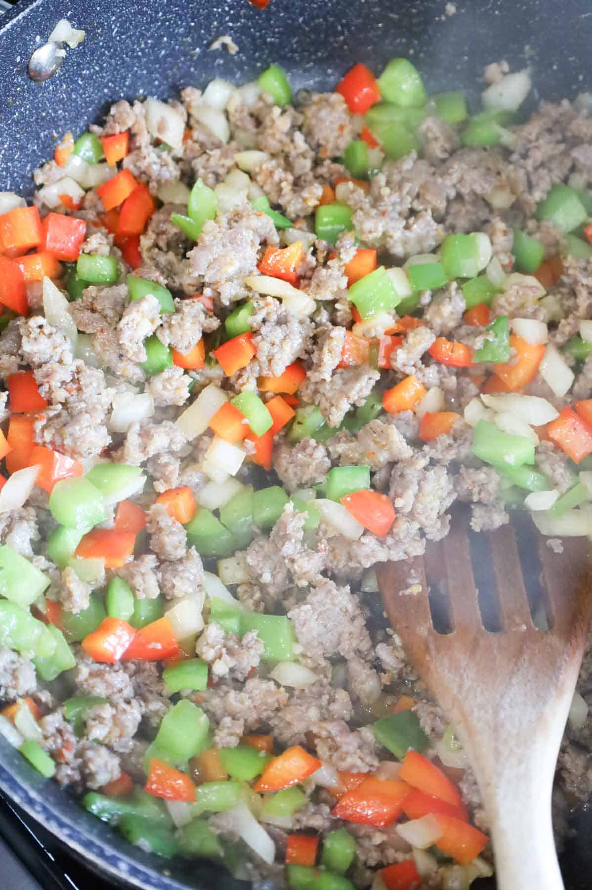 crumbled sausage and bell peppers in a skillet