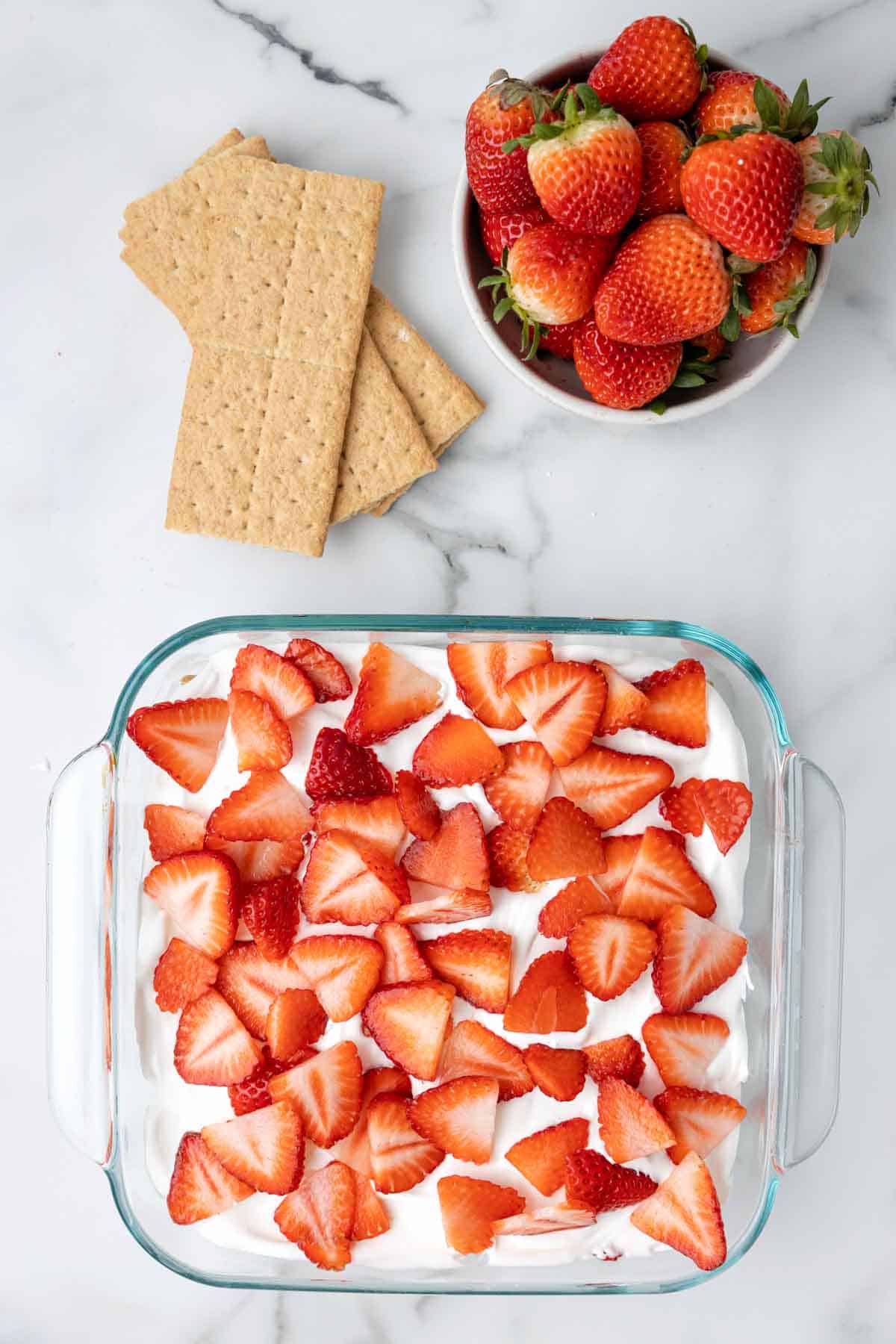 Strawberry Icebox Cake is a 3 ingredient no bake dessert recipe made with graham crackers, Cool Whip and fresh strawberries.