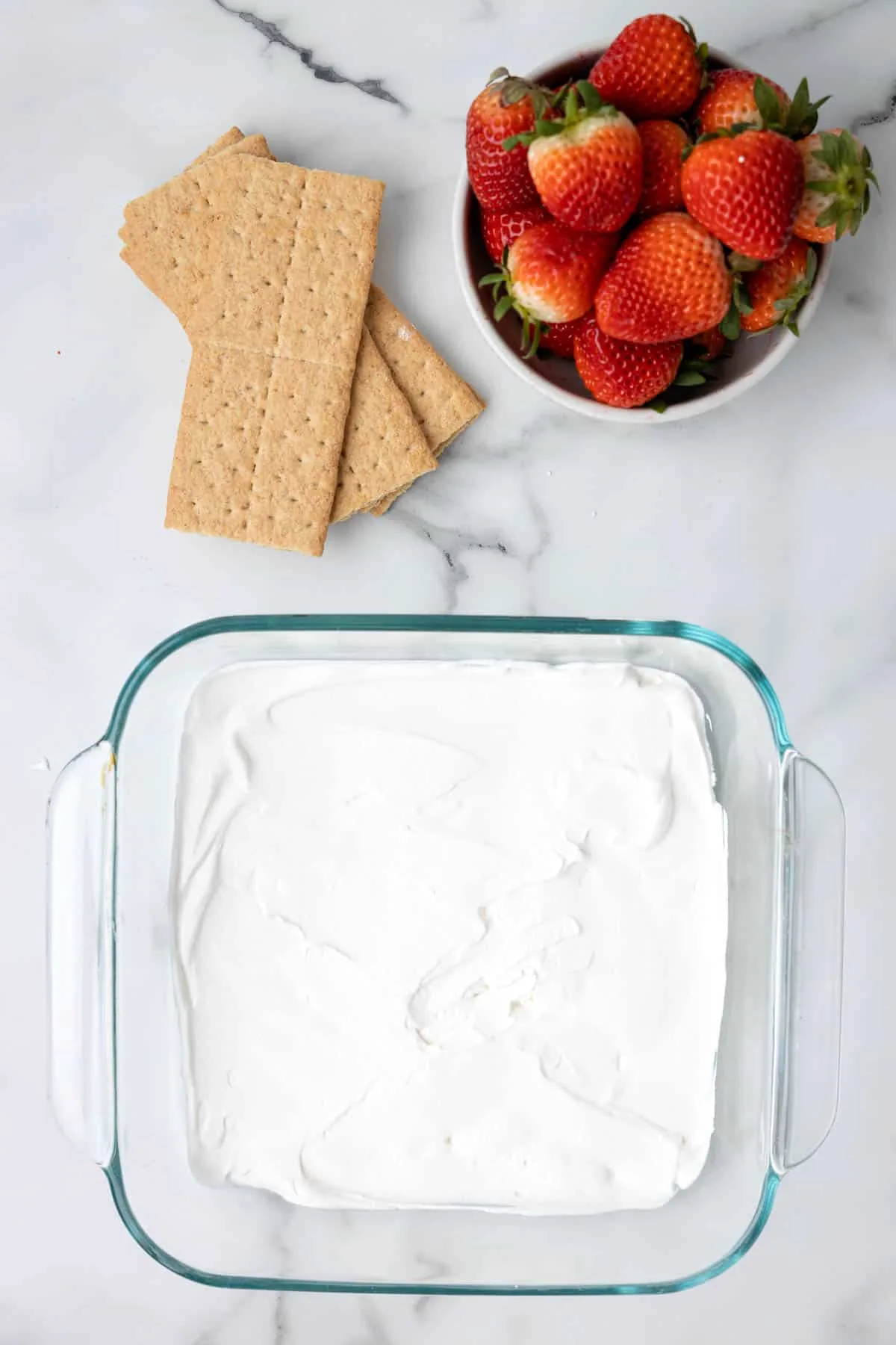 Cool whip spread in the bottom of a baking dish