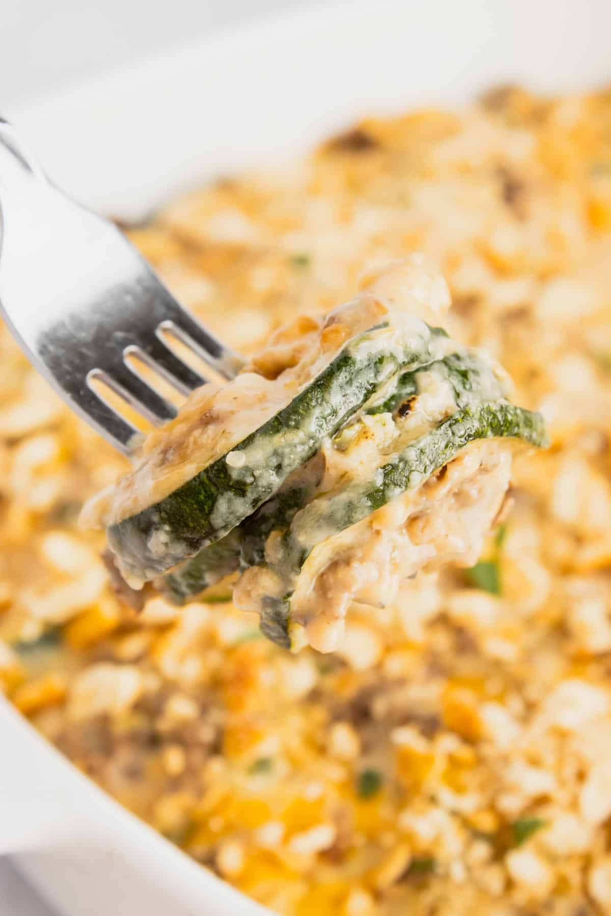 Zucchini Casserole with Ground Beef is a hearty casserole with layers of sliced zucchini, hamburger meat, a cream of mushroom based sauce mixture, shredded cheese and all baked with a Ritz cracker topping.