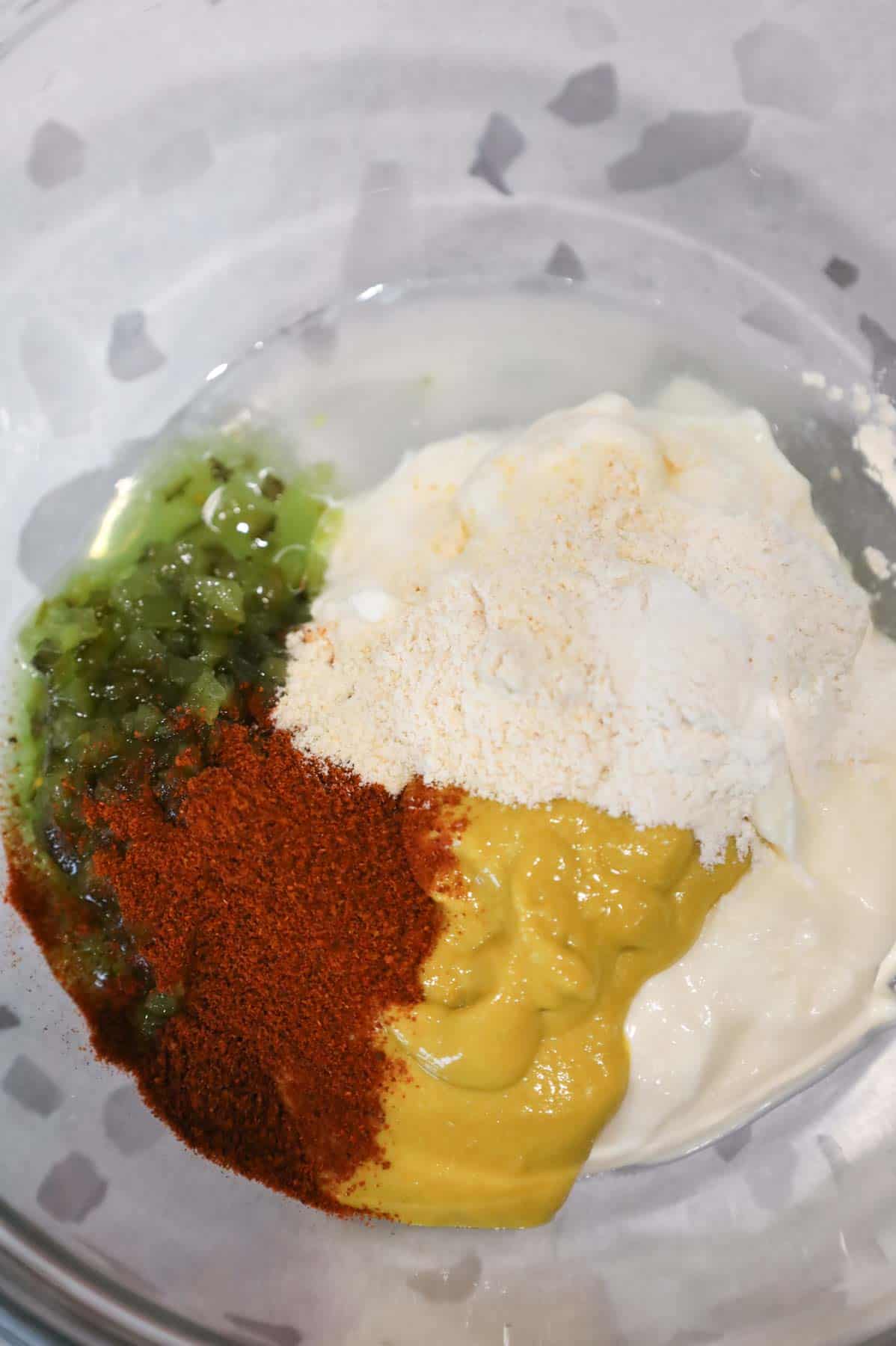 dill relish, mustard, mayo, paprika, onion powder and garlic powder in a mixing bowl